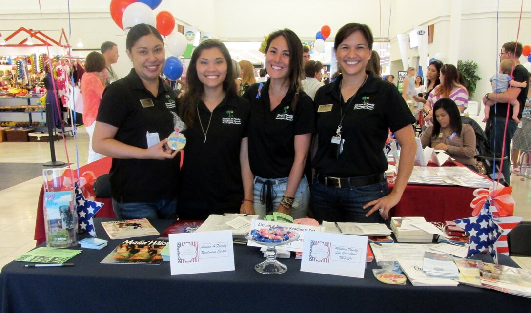 Members of the 36th Wing Airman and Family Readiness Center pose for a photo during Military Spouse Appreciation Day at the Base Exchange on Andersen Air Force Base, Guam May 17, 2014. The A&FRC hosted 15 helping agencies, who provided information tables to support more than 200 military spouses during the event. (Courtesy photo/Released)