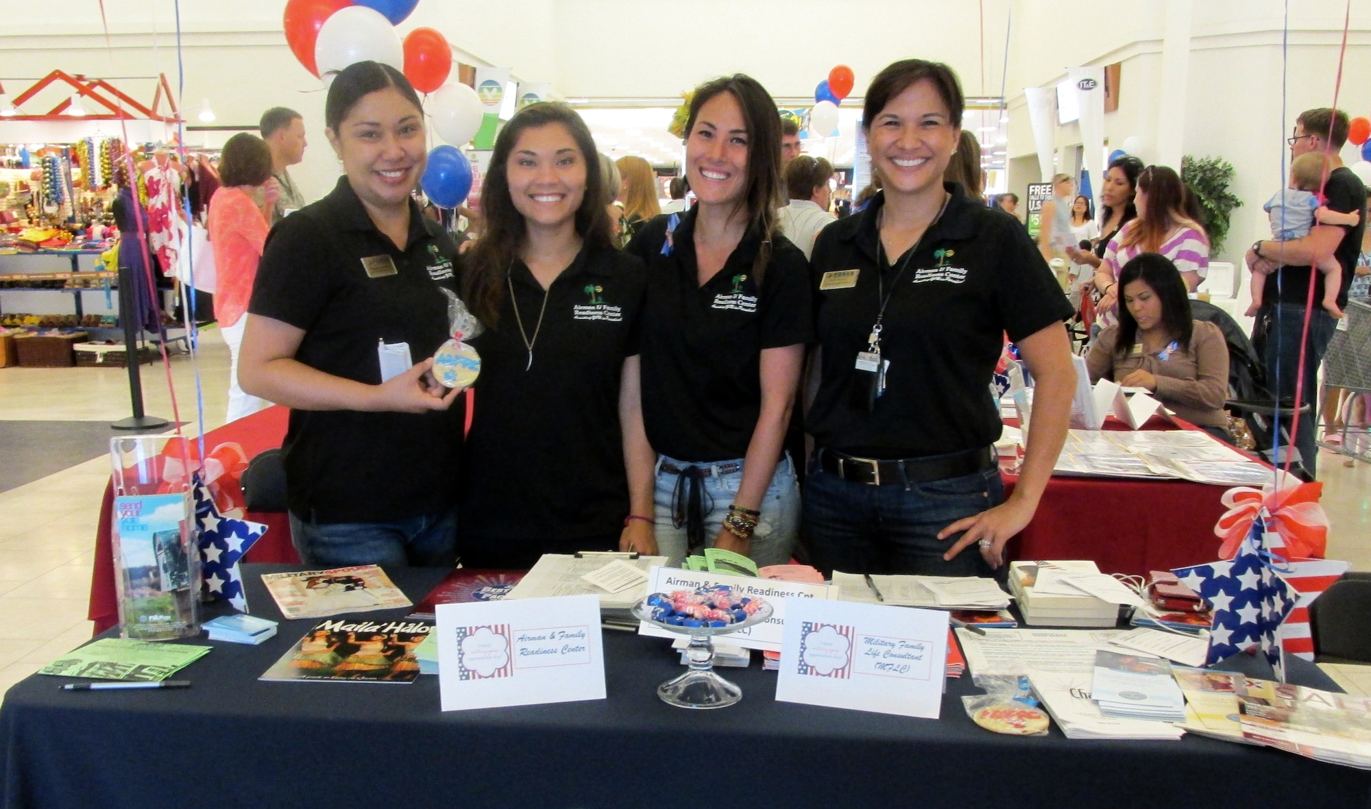 Members of the 36th Wing Airman and Family Readiness Center pose for a photo during Military Spouse Appreciation Day at the Base Exchange on Andersen Air Force Base, Guam May 17, 2014. The A&FRC hosted 15 helping agencies, who provided information tables to support more than 200 military spouses during the event. (Courtesy photo/Released)
