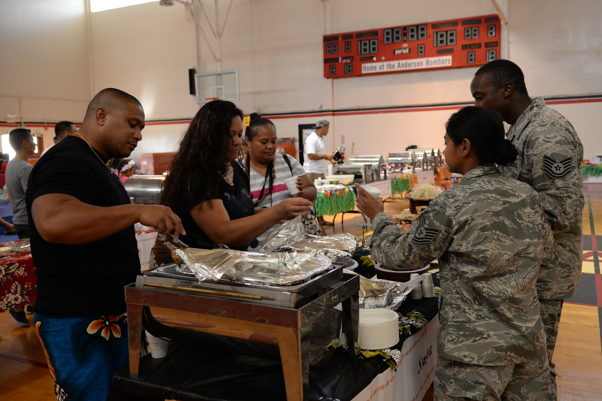 Volunteers serve food to guests during a festival recognizing Asian-Pacific American Heritage Month May 22, 2014, at Andersen Air Force Base, Guam. The festival had displays from different cultures that included food tasting, a raffle and a cultural performance. (U.S. Air Force photo by Airman 1st Class Amanda Morris/Released)