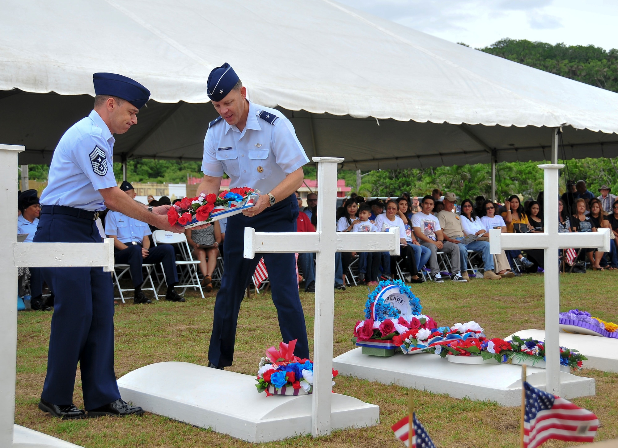 Brig. Gen. Steven Garland, 36th Wing Commander, and Chief Master Sgt. James Slisik, 36th Wing Command Chief, lay a wreath on a grave marker to honor fallen service members who were killed during Operation Enduring Freedom during the Memorial Day Ceremony at the Guam Governor’s Complex in Hagåtña, May 26, 2014. Various veterans’ organizations laid wreaths on the markers, which were set up to honor veterans who died in conflicts from World War I through Operation Enduring Freedom. (U.S. Air Force Photo by Staff Sgt. Brok McCarthy/Released)