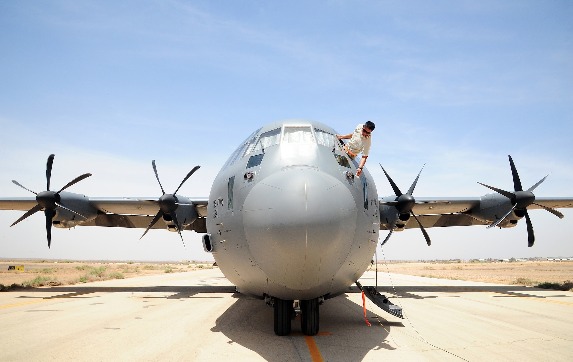 U.S. Air Force Staff Sgt. Juan Olmedo, an integrated avionics specialist with the 146th Aircraft Maintenance Squadron at Channel Islands Air National Guard Station, Calif., washes the windows of a C-130J Hercules during Exercise Eager Lion May 29, 2014, at an air base in northern Jordan. Both at home station and in deployed locations, C-130s are often called upon to respond to crises and to provide humanitarian assistance. (U.S. Air Force photo by Staff Sgt. Brigitte N. Brantley/Released)