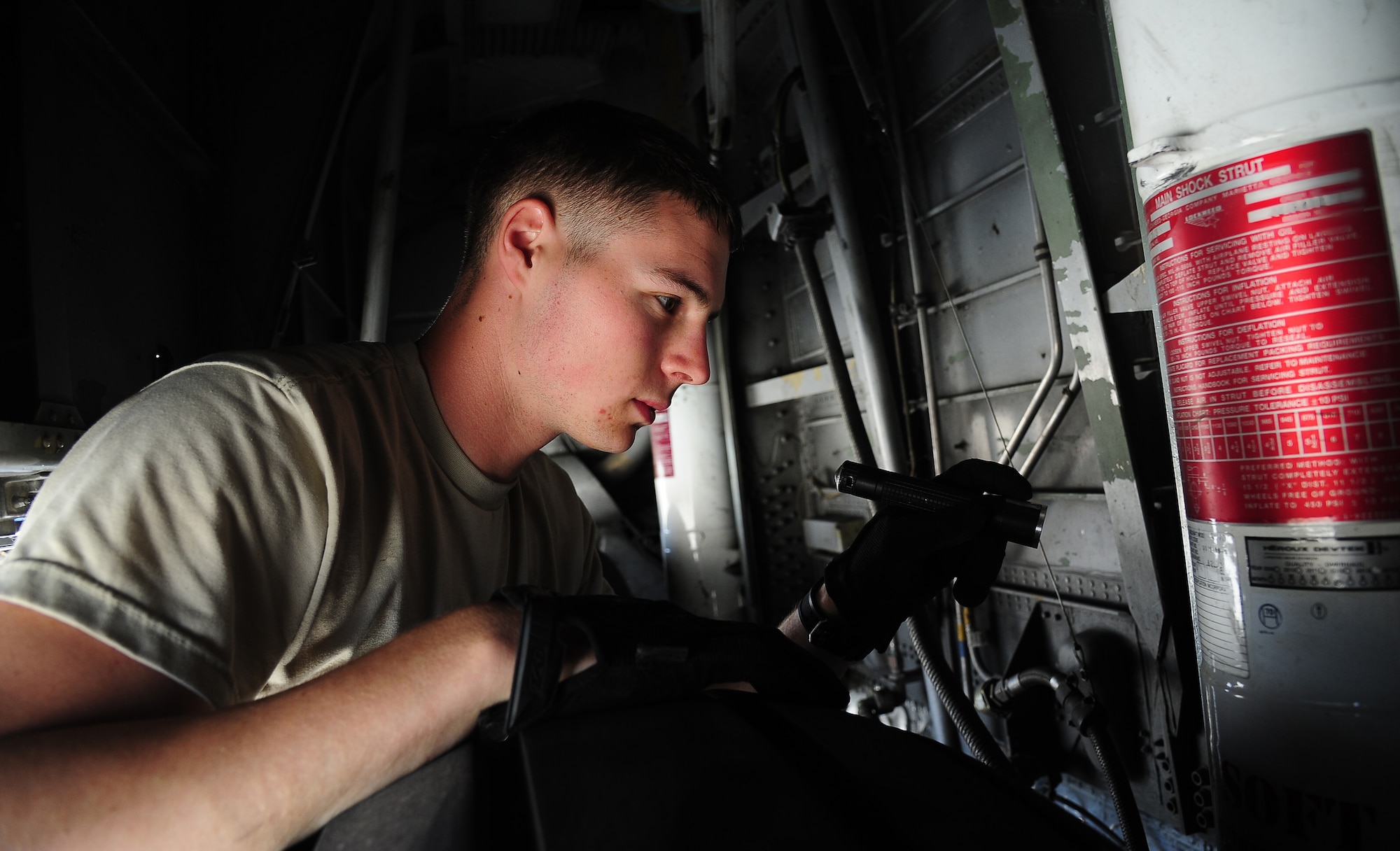 U.S. Air Force Senior Airman Beau Lewis, a crew chief with the 146th Aircraft Maintenance Squadron at Channel Islands Air National Guard Station, Calif., checks the tire gear of a C-130J Hercules during Exercise Eager Lion May 29, 2014, at an air base in northern Jordan. Having C-130s participate in Eager Lion gave other countries a chance to practice tactics with an aircraft they might not otherwise encounter.  (U.S. Air Force photo by Staff Sgt. Brigitte N. Brantley/Released)