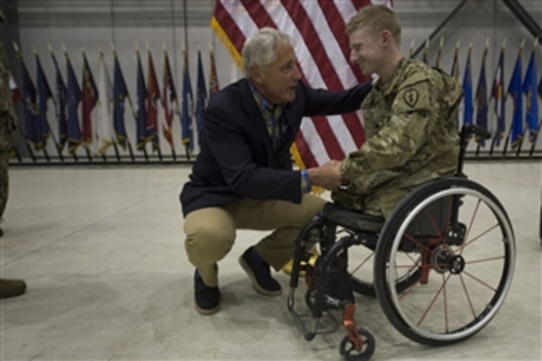 U.S. Defense Secretary Chuck Hagel speaks to a service member on Bagram Air Base, Afghanistan, June 1, 2014. Hagel is on a 12-day trip to Asia and Europe. 