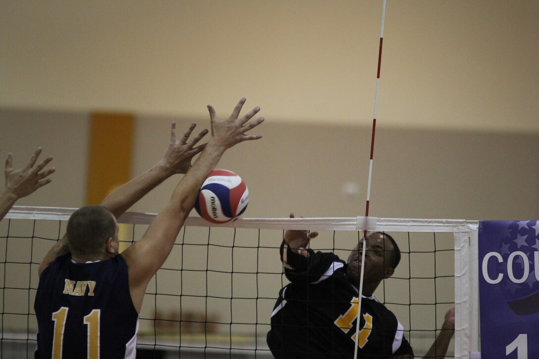 Army's SPC Derrick Clark drives the ball past Navy's PO2 Daniel Phillips during the 2014 Armed Forces Volleyball Championship held in conjunction with the 2014 USA Volleyball National Championship in Phoenix, AZ 26-28 May