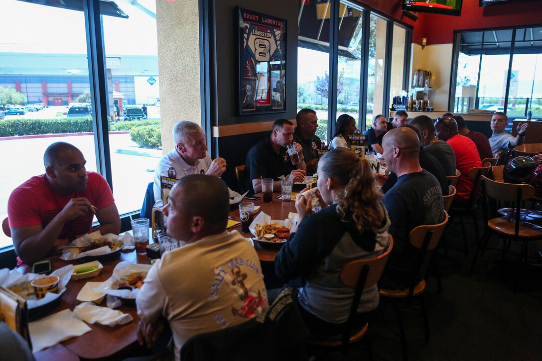 Marines with I Marine Expeditionary Force eat lunch together as part of a motorcycle ride at a local Buffalo Wild Wings in Murrieta, Calif., May 29, 2014. Nearly 20 Marines participated in the company-sponsored event, in which they rode approximately 70 miles in an effort to build camaraderie and promote safe motorcycle riding techniques. 