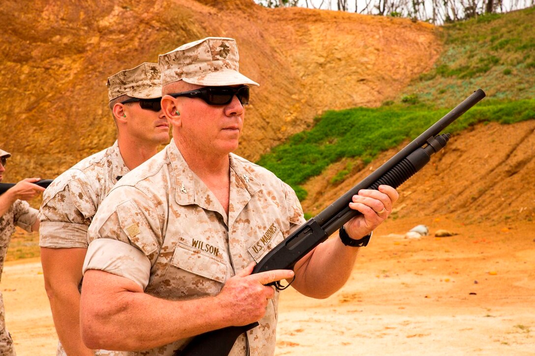 Col. Daniel H. Wilson prepares to fire an M590 shotgun May 24 in the Central Training Area during a friendly marksmanship competition. The competition was the culminating event of the 2014 Spring Commanders and Senior Enlisted Conference. The theme of the conference was “How we train and fight as a division,” which opened a dialogue on a range of command-related topics. The focus of the conference was 3rd Marine Division’s way ahead for 2015 and beyond. Wilson is the chief of staff for 3rd Marine Division, III Marine Expeditionary Force. 