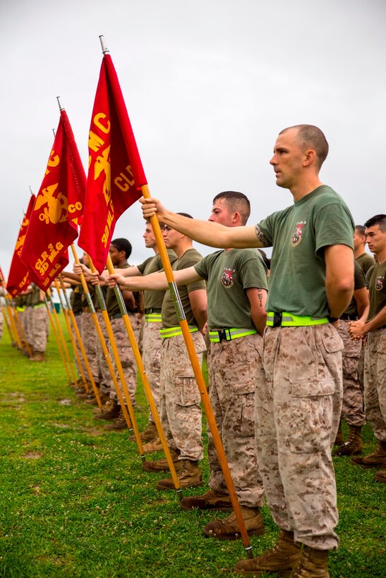 Marines and sailors stand in formation in preparation for a field meet May 23 at Camp Kinser. The field meet was held in celebration of 3rd Marine Logistics Group’s 56th anniversary. Despite the rainy weather and muddy field, the day’s events consisted of a pancake breakfast, 5-kilometer run, two multi-unit physical training sessions followed by unit competitions. The competitions pitted the most physically fit Marines within the respective battalions and regiments of 3rd MLG against each other in events such as pugil stick bouts, tug-of-war, Humvee pull, tire flip and functional fitness relay. This year’s winning unit was Combat Logistics Regiment 3, 3rd MLG, III Marine Expeditionary Force. 