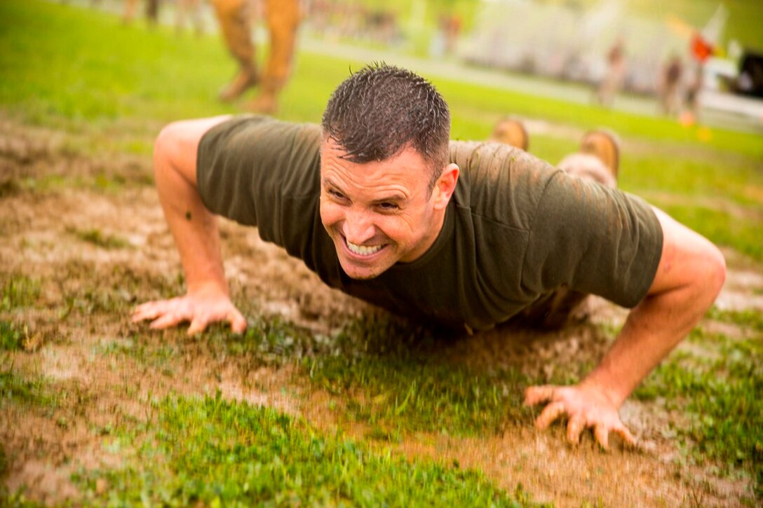 U.S. Navy Lt. Todd A. Eppel executes a pushup as he competes during his unit’s leg of a functional fitness relay May 23 at Camp Kinser as part of a field meet. The field meet was organized to celebrate 3rd Marine Logistics Group’s 56th anniversary. The competitions pitted the most physically fit Marines within the respective battalions and regiments of 3rd MLG against each other in events such as pugil stick bouts, tug-of-war, Humvee pull, tire flip and a functional fitness relay. This year’s winning unit was Combat Logistics Regiment 3, 3rd MLG, III Marine Expeditionary Force. Eppel is a dentist with 3rd Medical Battalion, 3rd MLG, III MEF.