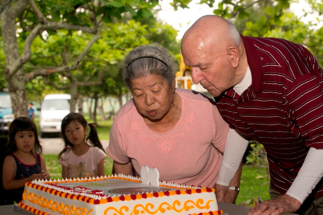 Retired Gunnery Sgt. Samuel C. Bowser, right, and his wife, Yoshiko, blow out birthday candles at a picnic celebrating his 90th birthday May 25 at Comprehensive Park. The couple celebrated their 50th wedding anniversary. Bowser, a native of Duncansville, Pa., served in World War II, the Korean War and the Vietnam War during his 26-year military career. He was a logistics noncommissioned officer and left the Marine Corps with an honorable discharge after the Vietnam War. 