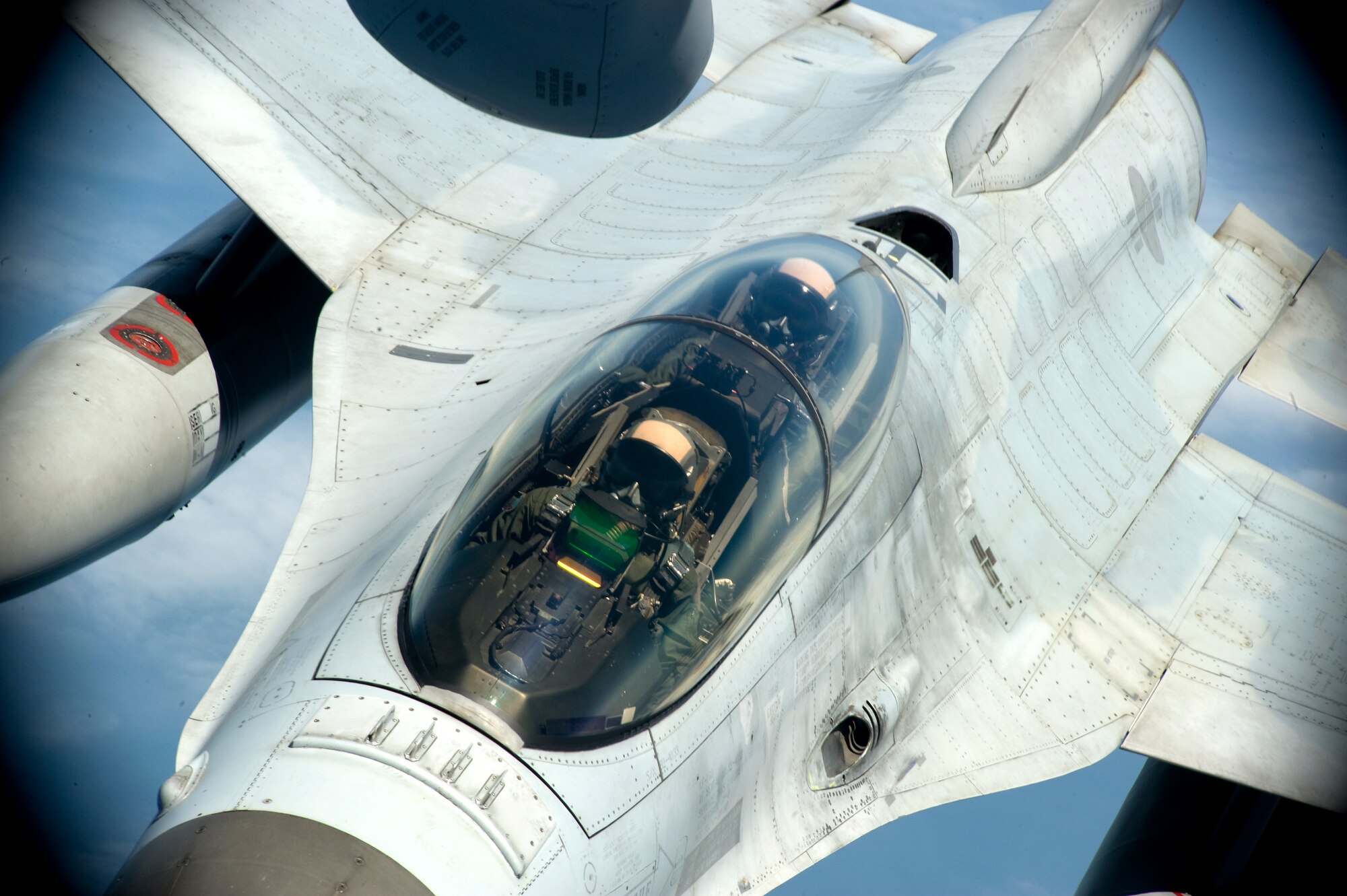 Two Republic of Korea air force F-16 Fighting Falcon pilots approach a U.S. Air Force KC-135 Stratotanker from the 909th Air Refueling Squadron over the ocean May 21, 2014. Training with other allies in the region helps bolster the Air Force?s strategic presence in the Asia-Pacific region. (U.S. Air Force photo by Senior Airman Maeson L. Elleman)