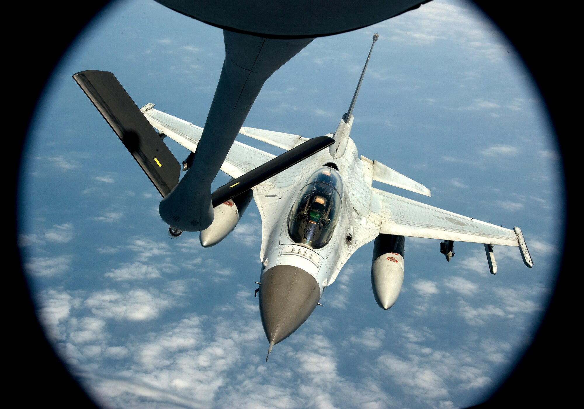 A Republic of Korea air force F-16 Fighting Falcon approaches a U.S. Air Force KC-135 Stratotanker from the 909th Air Refueling Squadron over the ocean May 21, 2014. The training allowed U.S. and ROK service members to bolster procedures and improve interoperability between the two allies. (U.S. Air Force photo by Senior Airman Maeson L. Elleman)