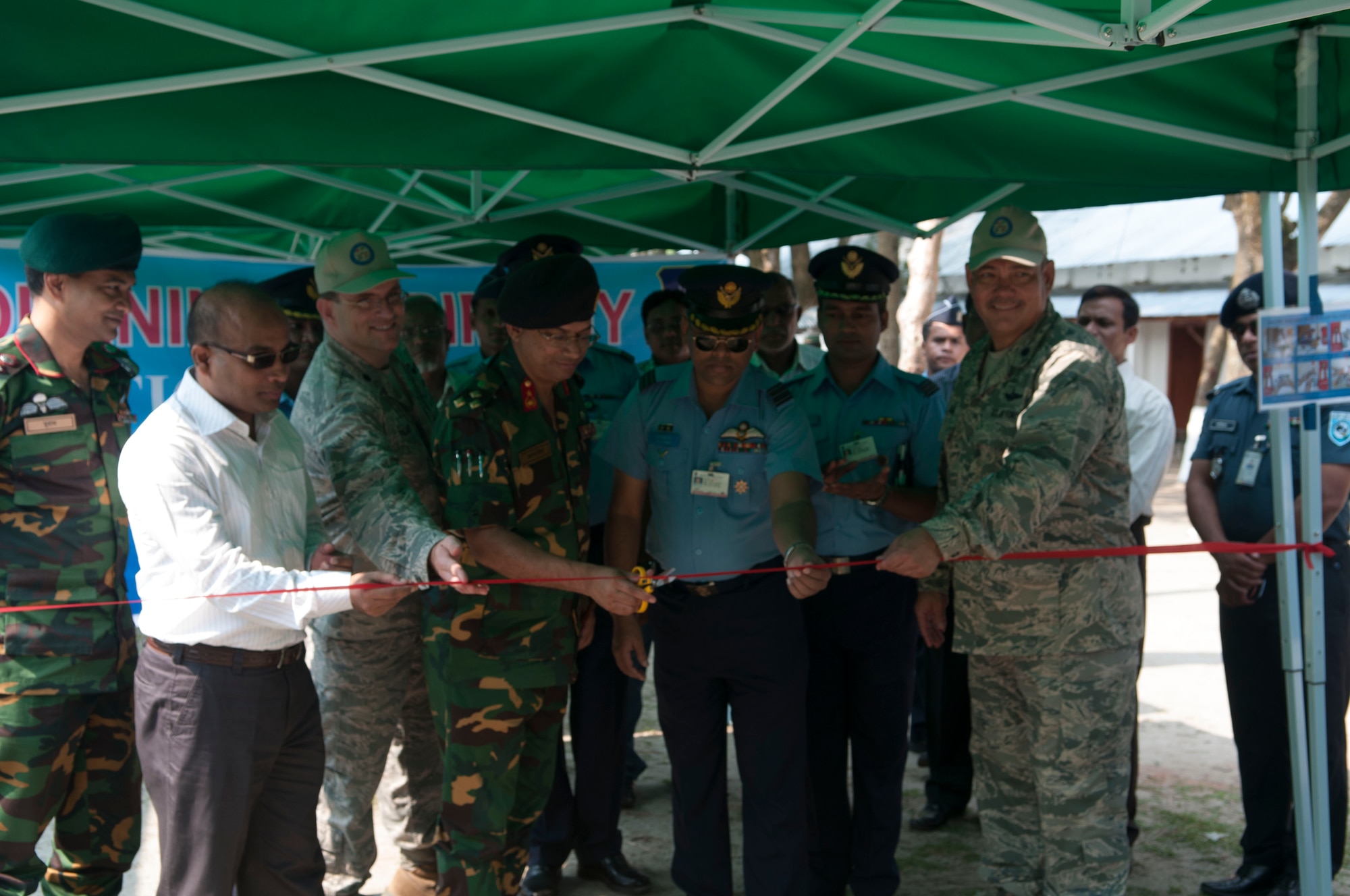 Bangladesh Army Brig. Gen. Mahbub Ahmed Jakaria, Bangladesh Air Force Wing Commander Md. Abu Rayhan, U.S. Air Force Lt. Col. Alvin Alana, U.S. Air Force Lt. Col. Wesley Palmer and other leadership cut the ribbon at the opening ceremony for Operation Pacific Angel, June 1, 2014 in Rangpur, Bangladesh. U.S and Bangladesh military members will work together for the next week to provide humanitarian medical and engineering assistance.
