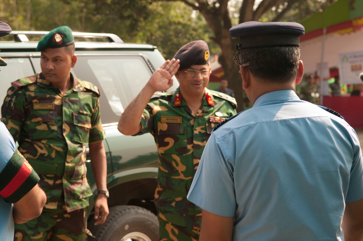 Bangladesh Army Brig. Gen. Mahbub Ahmed Jakaria returns the salute of several Bangladesh Air Force officers upon his arrival at the Health Services Operation site in Rangpur Bangladesh, June 1, 2014. Jakaria visited the site prior to opening on the first day of Operation Pacific Angel, a joint and combined humanitarian assistance exercise held in various countries several times a year and includes medical, dental, optometry, engineering programs and a variety of subject-matter expert exchanges. (U.S. Air Force photo/ Capt. Caitlin Suttie)
