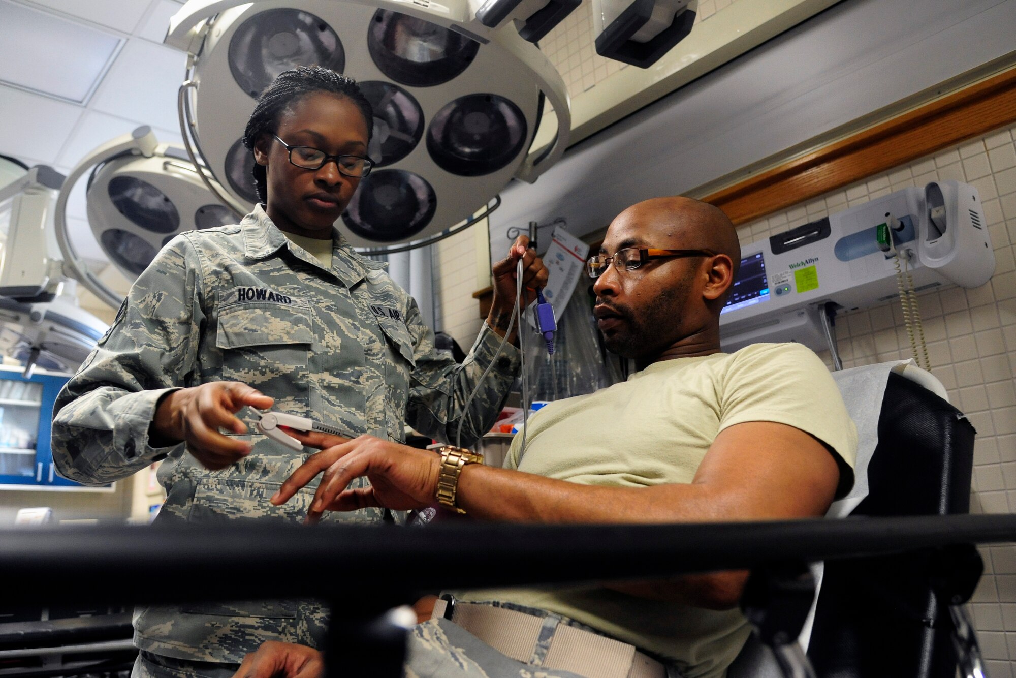 Senior Airman Brandi Howard, 8th Medical Operations Squadron ambulance services shift leader, performs a blood pressure examination on a simulated patient before drawing blood during a training scenario at Kunsan Air Base, Republic of Korea, May 28, 2014. The 8th Medical Group continues to focus on comfort for both the patients and providers as they prepare for upcoming manning gaps. (U.S. Air Force photo by Senior Airman Taylor Curry/Released) 
