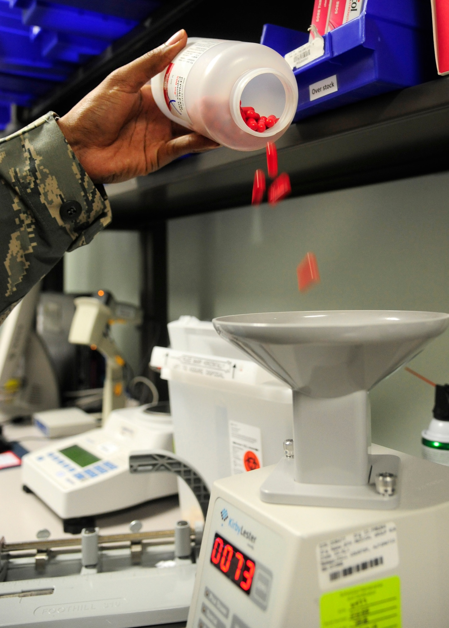 Staff Sgt. Lavondre Chamberlin, 8th Medical Support Squadron pharmacy technician, dispenses pills into an automatic counter at Kunsan Air Base, Republic of Korea, May 28, 2014. The pharmacy hours of operation are 8 a.m. to 5 p.m. As they prepare for upcoming manning gaps, the 8th Medical Group remains focused on comfort for both the patients and providers. (U.S. Air Force photo by Senior Airman Taylor Curry/Released) 