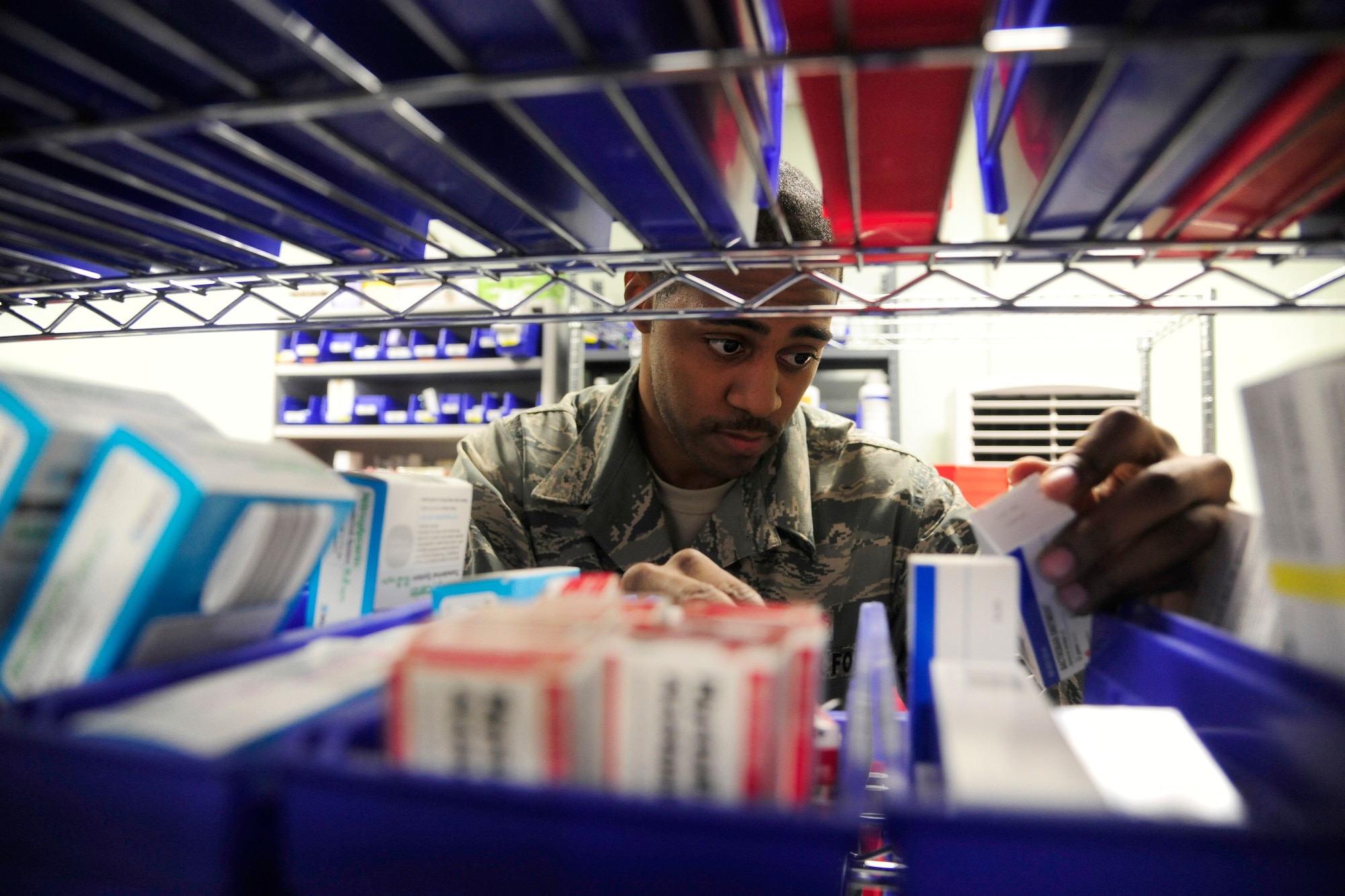 Staff Sgt. Lavondre Chamberlin, 8th Medical Support Squadron pharmacy technician, organizes prescriptions at Kunsan Air Base, Republic of Korea, May 28, 2014. The pharmacy provides on average more than 60 prescriptions a day. As they prepare for upcoming manning gaps, the 8th Medical Group remains focused on comfort for both the patients and providers. (U.S. Air Force photo by Senior Airman Taylor Curry/Released) 