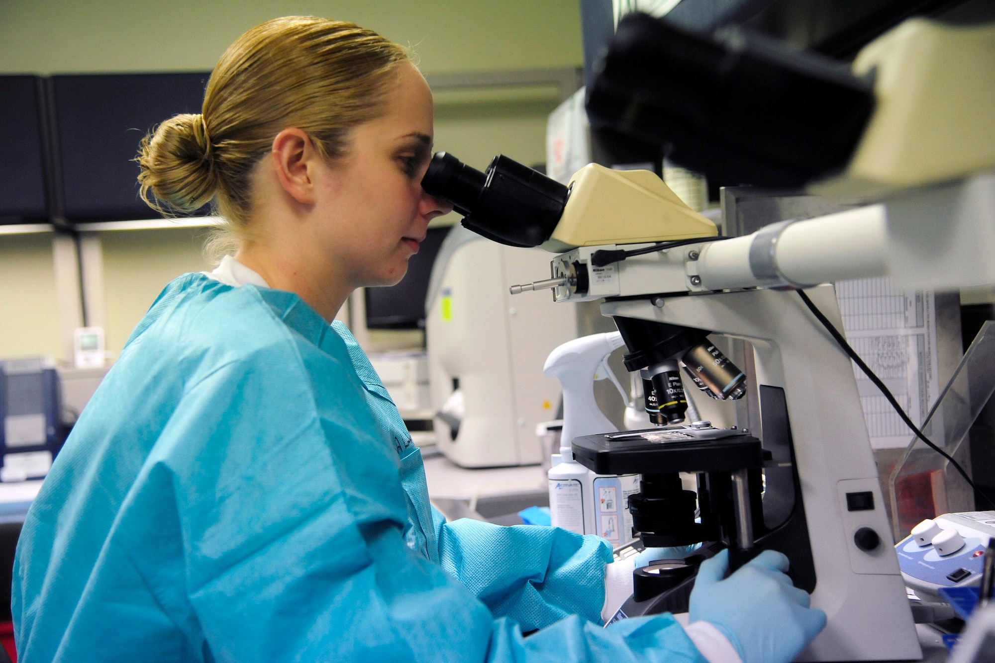 Senior Airman Melissa Lambert, 8th Medical Support Squadron laboratory technician, performs a microscopic exam at Kunsan Air Base, Republic of Korea, May 28, 2014. The 8th Medical Group continues to focus on comfort for both the patients and providers as they prepare for upcoming manning gaps. (U.S. Air Force photo by Senior Airman Taylor Curry/Released) 