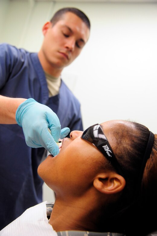 Master Sgt. Nicole Randall, 8th Logistics Readiness Squadron maintenance support chief, receives a mouth impression administered by Senior Airman David Tierney, 8th Medical Operations Squadron dental technician, at Kunsan Air Base, Republic of Korea, May 28, 2014. Mouth impressions are generally used for creating a retainer or sports guard. As they prepare for upcoming manning gaps, the 8th Medical Group remains focused on comfort for both the patients and providers. (U.S. Air Force photo by Senior Airman Taylor Curry/Released) 