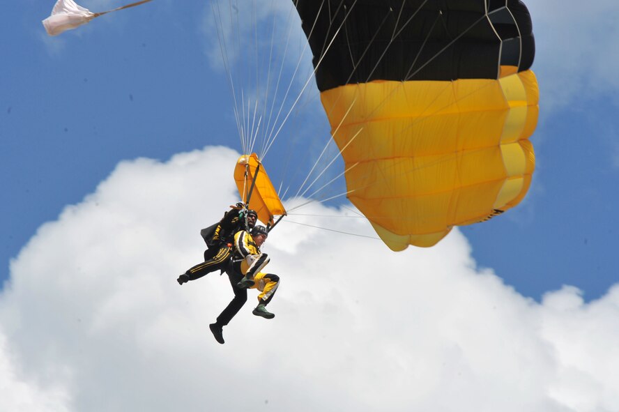 Senior Airman Shane Bedard tandem jumps with the U.S. Army Parachute Team, “Golden Knights”, during SkyFest 2014 at Fairchild Air Force Base, Wash., June 1, 2014. SkyFest is Fairchild’s air show and open house, giving the local and regional community the opportunity to view Airmen and the base’s resources. The event typically draws more than 150,000 people. SkyFest 2008, headlined by the Blue Angels, was the largest event held in Spokane since the 1974 World’s Fair. (U.S. Air Force photo by Staff Sgt. Veronica Montes/Released)