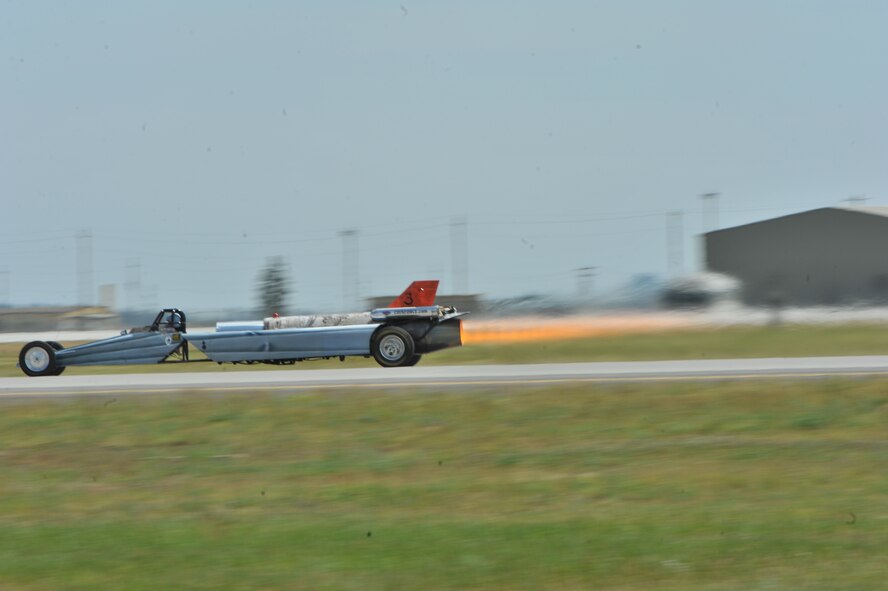 Bill Braack drives the Smoke-N-Thunder jet car during a performance during SkyFest 2014 at Fairchild Air Force Base, Wash., June 1, 2014. The jet car is equipped with a J34-48 engine originally used in the North American Buckeye T-2A aircraft. The jet car has 10,000 horsepower and 6,000 pounds of thrust with an afterburner. The jet car races at speeds approaching nearly 400 mph. During the performance, Braack pulls 4.5 Gs when accelerating and experiences 11 Gs of negative force as the car comes to a stop. (U.S. Air Force photo by Staff Sgt. Veronica Montes/Released)