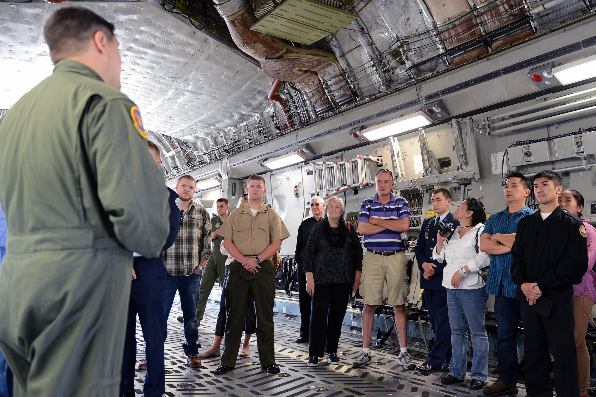 Staff Sgt. Brandon Ybarra (far left), 4th Airlift Squadron loadmaster, speaks to Junior ROTC award recipient cadets and their family and friends about a C-17 Globemaster III May 31, 2014, at Joint Base Lewis-McChord, Wash. Cadets began their tour with the opportunity to ask pilots and loadmasters questions about the capabilities of the C-17. (U.S. Air Force photo/Senior Airmen Brenden Marlin)