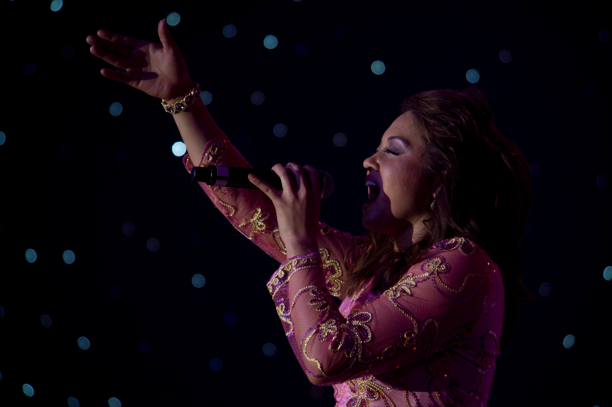 Staff Sgt. Lafray Miller, 744th Communications Squadron cyber transport craftsman, sings for the crowd during the Tops in Blue performance at Tays Center, Alamogordo, N.M., May 31. Tops in Blue is comprised of vocalists, musicians, dancers and technicians serving in the U.S. Air Force. The group’s primary mission is to perform for military personnel and their families throughout the world. (U.S. Air Force photo by Airman 1st Class Aaron Montoya / Released)