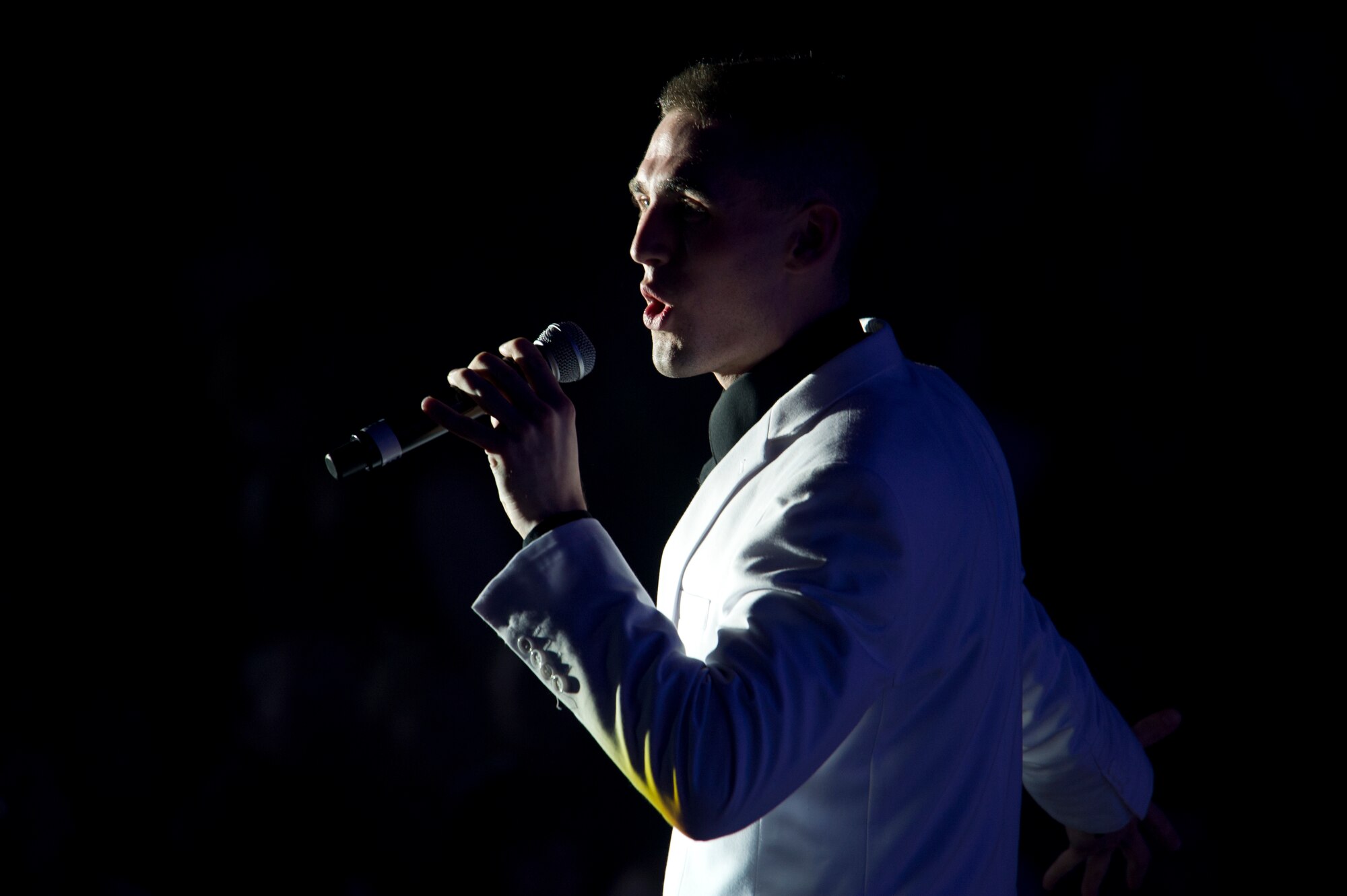 Airman 1st Class Kyle McCarty, 15th Maintenance Squadron aircraft maintenance journeyman, sings for the crowd during the Tops in Blue performance at Tays Center, Alamogordo, N.M., May 31. Tops in Blue is comprised of vocalists, musicians, dancers and technicians serving in the U.S. Air Force. The group’s primary mission is to perform for military personnel and their families throughout the world. (U.S. Air Force photo by Airman 1st Class Aaron Montoya / Released)