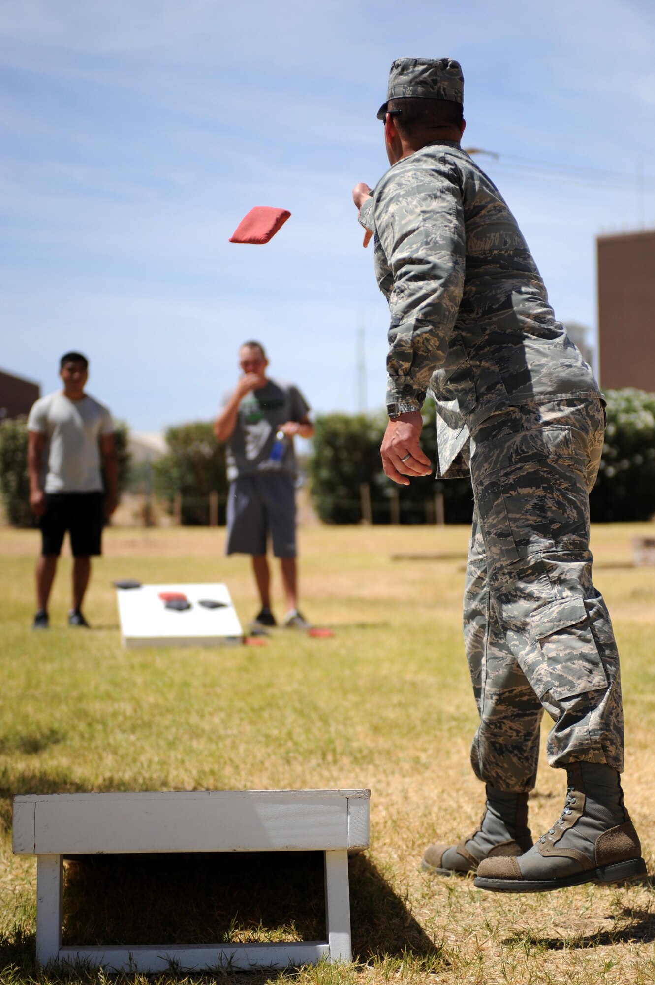 Desert Lightning Team members play a game of Cornhole in support of Comprehensive Airman Fitness Day at Davis-Monthan Air Force Base, Ariz., June 2, 2014. CAF Day is an Air Force-wide initiative based on improving Airman readiness by solidifying the four pillars of CAF. Today was focused on the social pillar, which is meant to develop and maintain trusted, valued friendships that are personally fulfilling and foster communication, including the exchange of ideas, views and experiences. (Air Force Photo by Airman 1st Class Cheyenne Morigeau/ Released)  