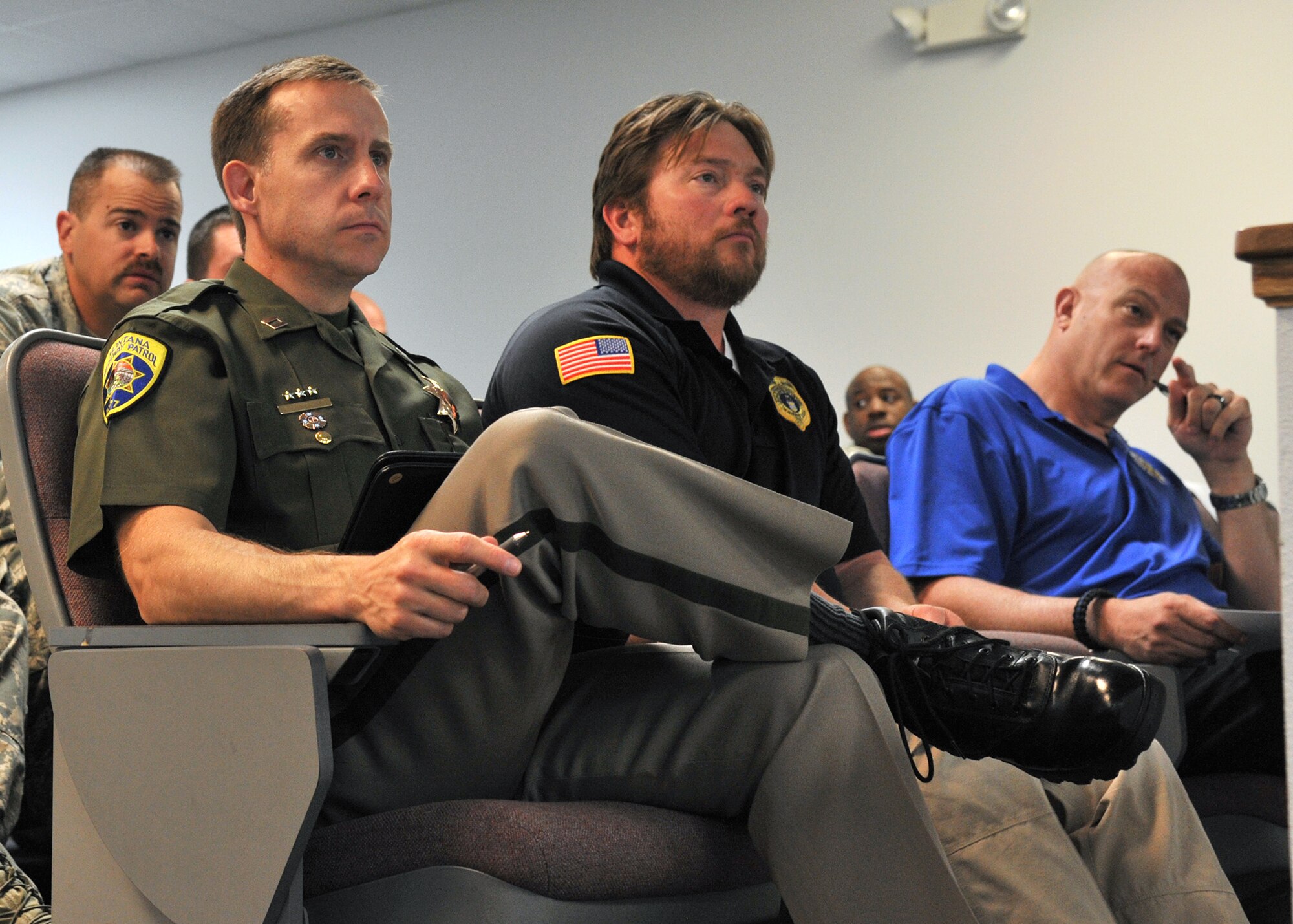 (From left to right) Capt. Bob Armstrong, Montana Highway Patrol, Special Agent Brian Birdwell, Air Force Office of Special Investigations Det. 806, and Capt. John Shaffer, Great Falls Police Department, take notes during the Local Incident Response Plan conference May 29 at Malmstrom Air Force Base. The conference was an opportunity for military and civilian law enforcement agencies from around the state to discuss the response contingency if a nuclear weapon was ever threatened by an adversary. (U.S. Air Force photo / John Turner)