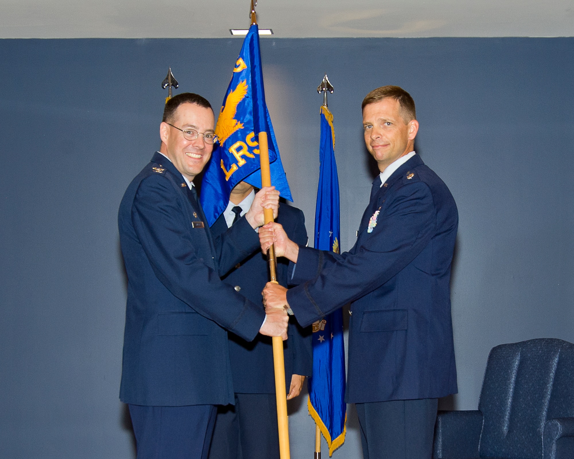 Colonel Christopher D. Holmes, 325th Mission Support Group commander, passes the 325th Logistics Readiness Squadron guidon to Lt. Col. Anthony J. Mullinax during the assumption of command ceremony June 2. Mullinax previously served as the Logistics Liaison Officer for the Defense Logistics Agency, Yongsan Army Garrison, Korea. (U.S. Air Force photo by Airman 1st Class Alex Echols)