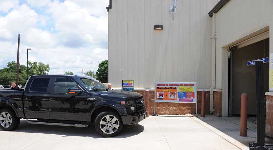 Staff Sgt. Pamela Bradford, 2nd Maintenance Group command staff, drives into the Auto Hobby Shop's Car Wash on Barksdale Air Force Base, La., June 2, 2014. Bradford was the first patron to use the new car wash. (U.S. Air Force photo/Senior Airman Benjamin Gonsier)