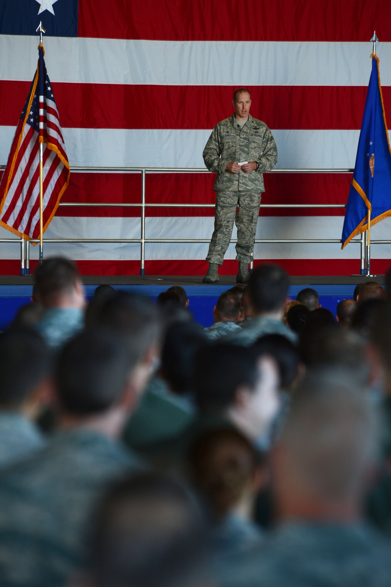 U.S. Air Force Col. Stephen Jost, 20th Fighter Wing commander, speaks during an all-call in Hangar 1200, June 2, 2014 at Shaw Air Force Base, S.C. Jost, having assumed command of the 20th FW three days earlier, spoke about his expectations of the 20th FW to include combat readiness, compliance, community and the core values. (U.S. Air Force photo by Airman 1st Class Jensen Stidham/Released)