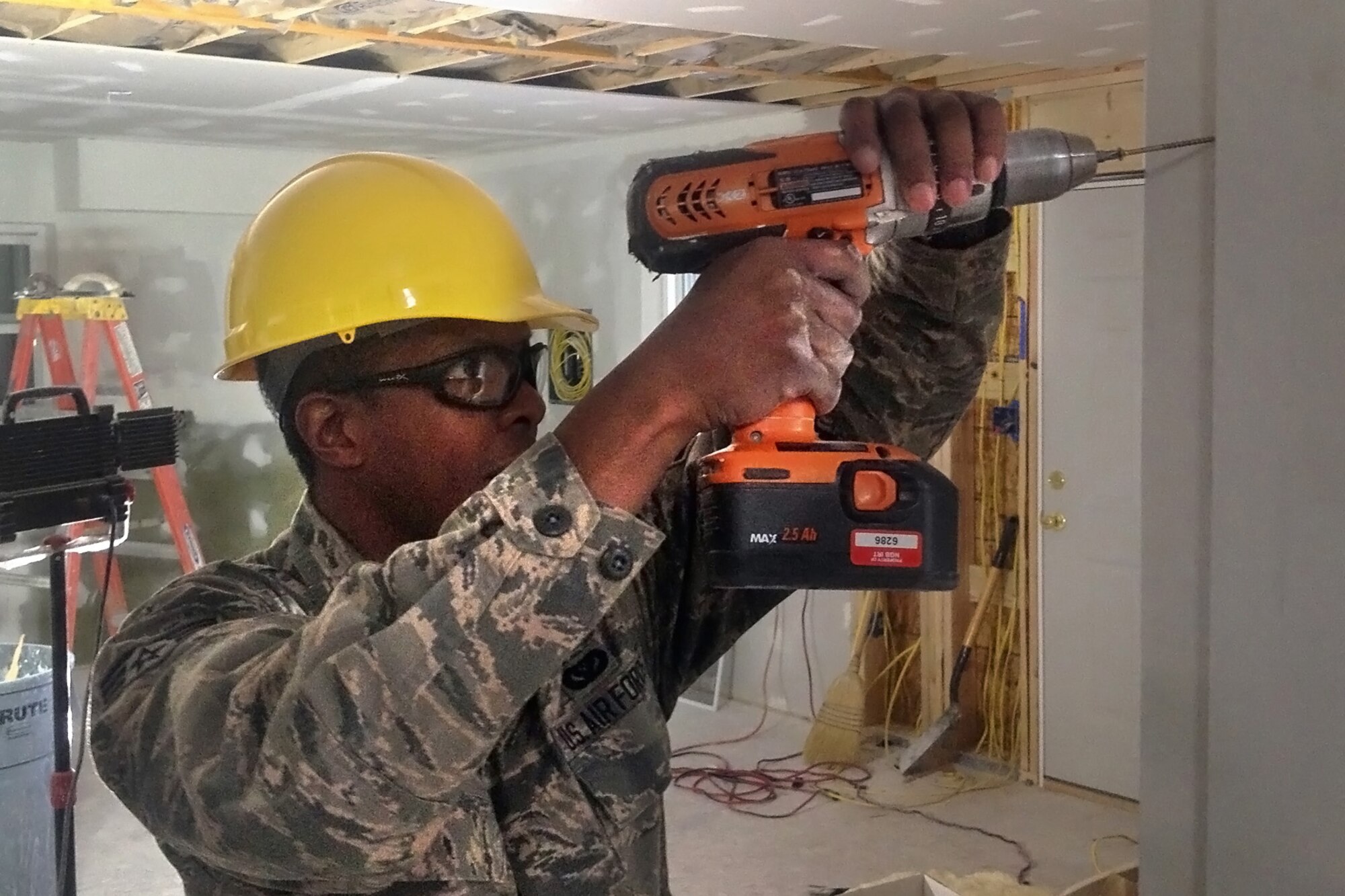 Senior Airman James Burton, 434th Civil Engineer Squadron water and fuels journeyman, hangs drywall at a home being constructed March 4, 2014 in Gallup, N.M. Airmen from Grissom Air Reserve Base, Ind., constructed houses recently  for Native American families in New Mexico as part of a training opportunity. (U.S. Air Force photo/Master Sgt. Josh Moormann)