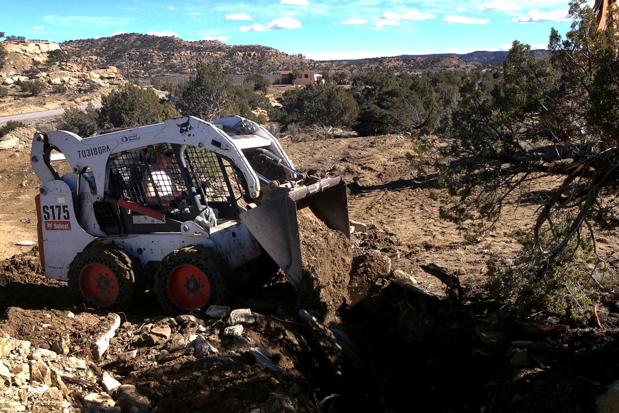 Senior Airman Edward Black, 434th Civil Engineer Squadron pavements and equipment operator, backfills a utilities trench near Gallup, N.M., on March 3, 2014. Airmen from Grissom Air Reserve Base, Ind., recently constructed houses for Native American families in New Mexico as part of a training opportunity. (U.S. Air Force photo/Master Sgt. Josh Moormann)