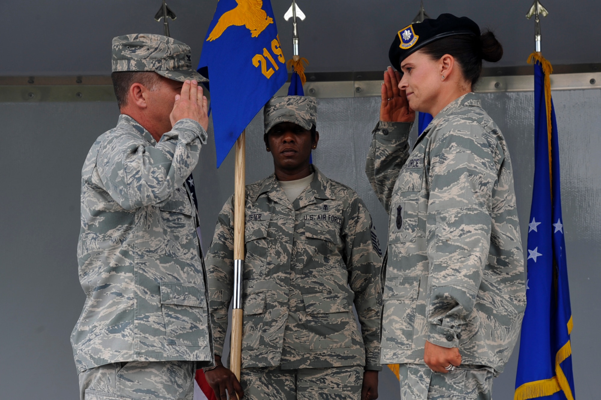 PETERSON AIR FORCE BASE, Colo. – Col. Charles Arnold, 21st Mission Support Group commander, passes the 21st Security Forces Squadron command to Lt. Col. Nicole Roberts, incoming 21st SFS commander, during the squadron’s change of command ceremony May 30. Before assuming command of the 21st SFS, Roberts was the chief of the Air Force Space Command Inspector General operations branch, and replaces outgoing commander Lt. Col. Sean Tiernan, who will join AFSPC A7. (U.S. Air Force photo/Robb Lingley)