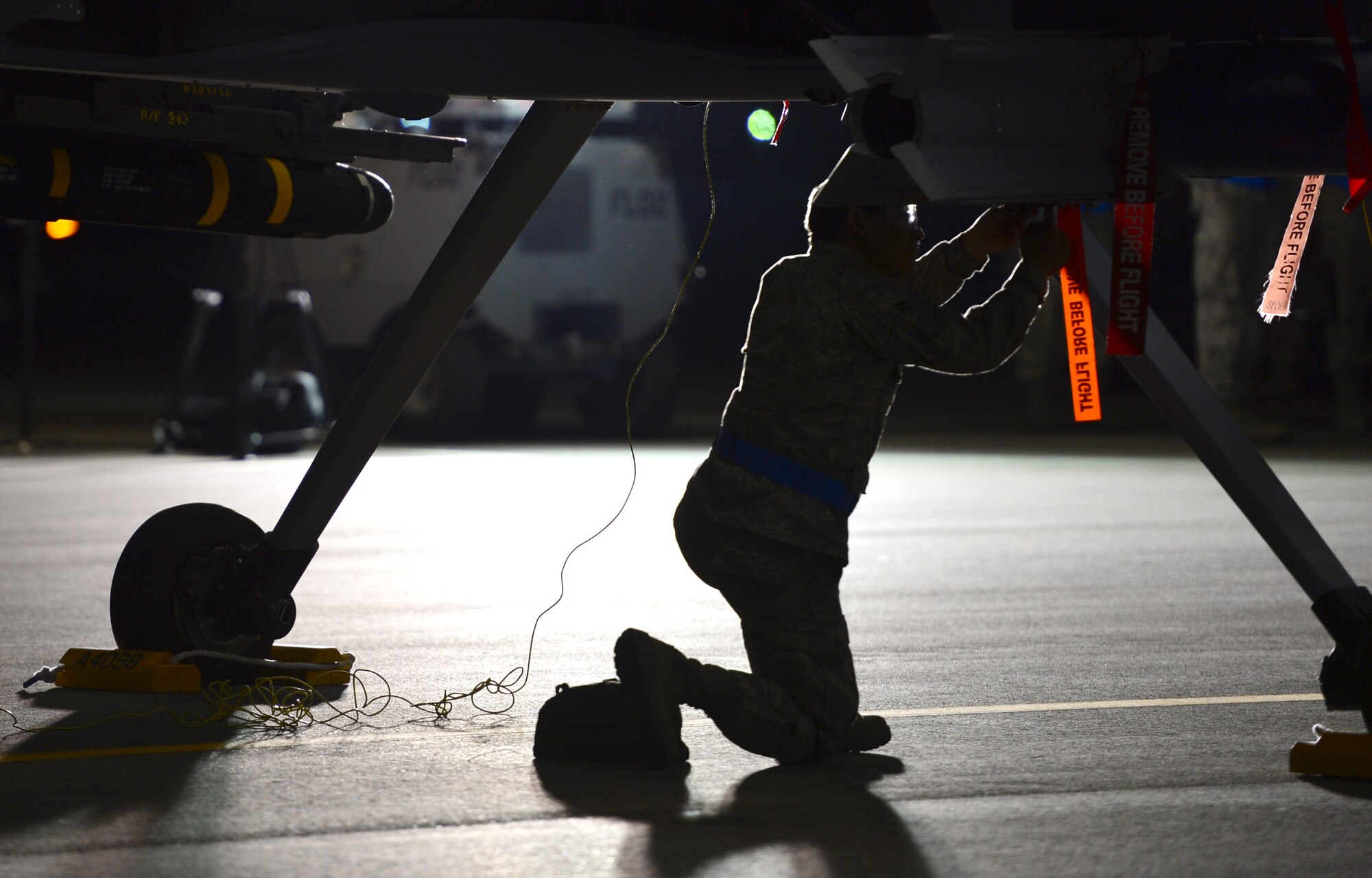 An Airmen assigned to the 432nd Maintenance Group, performs maintenance on an MQ-9 Reaper prior to a launch at Creech Air Force Base, Nev., May 12, 2014. The 432nd Maintenance Group has continuously exceeded the RPA standard mission capable rate of 86 percent set by Air Combat Command through sound maintenance practices. Mission capable means the aircraft has no supply or maintenance issues preventing it from successfully completing a mission. (U.S Air Force photo by Staff Sgt. N.B./Released)