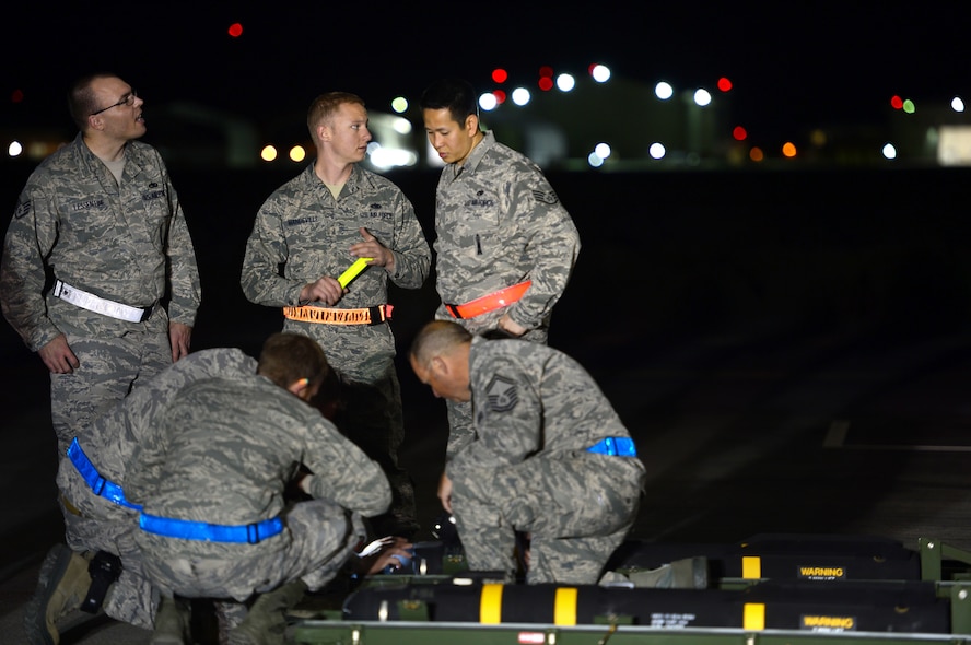 Airmen from the 432nd Aircraft Maintenance Squadron Tiger Aircraft Maintenance Unit weapons load crew inspect an AGM- 114 Hellfire missile loaded on an MQ-9 Reaper prior to launch at Creech Air Force Base, Nev., May 12, 2014. The 432nd Maintenance Group has continuously exceeded the RPA standard mission capable rate of 86 percent set by Air Combat Command through sound maintenance practices. Mission capable means the aircraft has no supply or maintenance issues preventing it from successfully completing a mission. (U.S Air Force photo by Staff Sgt. N.B./Released)