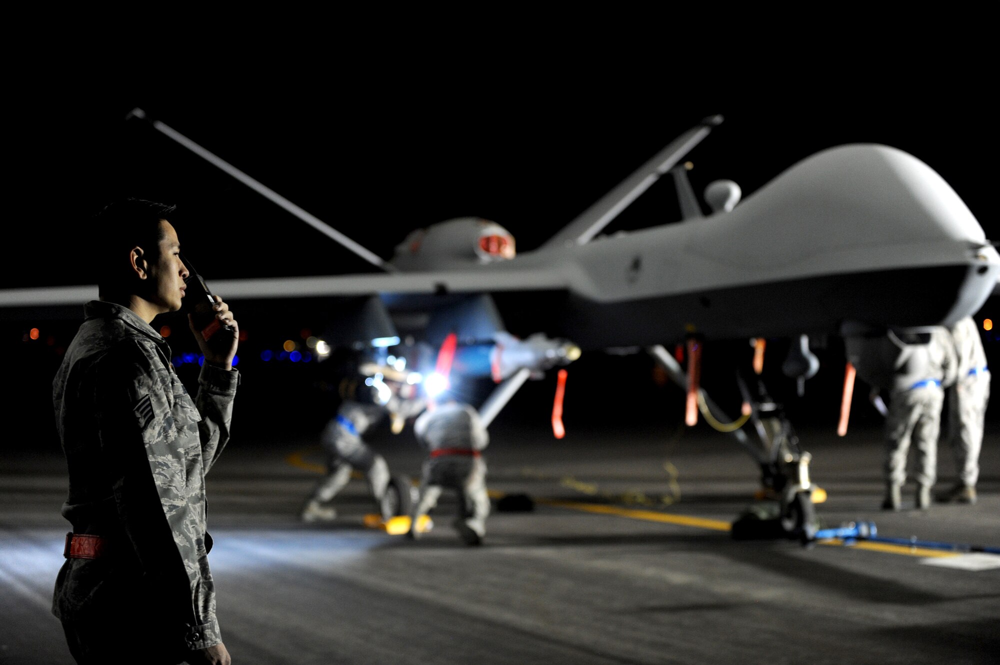 Staff Sgt. Trung, 432nd Aircraft Maintenance Squadron weapons load crew chief, reports a munitions load to the munitions operations center at Creech Air Force Base, Nev., May 12, 2014. The 432nd Maintenance Group ensures that Airmen, MQ-1 Predator and MQ-9 Reaper aircraft, ground control stations, Predator Primary Satellite Links, and a globally-integrated communications network are fully capable to support aircrew training, combat operations, operational test and evaluation, and natural disaster support. (U.S. Air Force photo by Senior Master Sgt. C.R./Released)