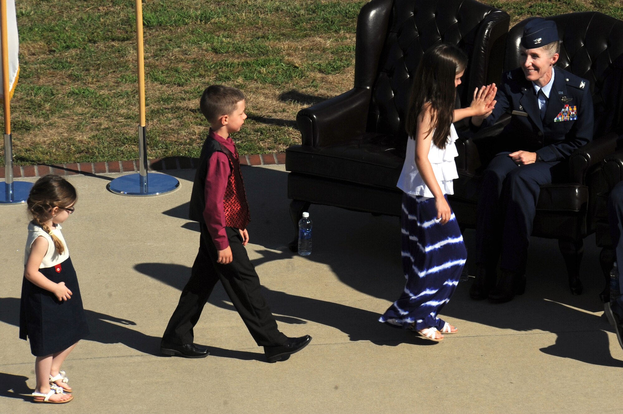 Col. Jeannie Leavitt, outgoing 4th Fighter Wing commander, high fives her children and the child of Col. Mark Slocum, incoming 4th FW commander, during the 4th FW change of command ceremony, June 2, 2014, at Seymour Johnson Air Force Base, North Carolina. Leavitt is leaving the 4th FW to become the Principal Military Assistant to the Secretary of Defense at the Pentagon. (U.S. Air Force photo/Airman 1st Class Aaron J. Jenne)