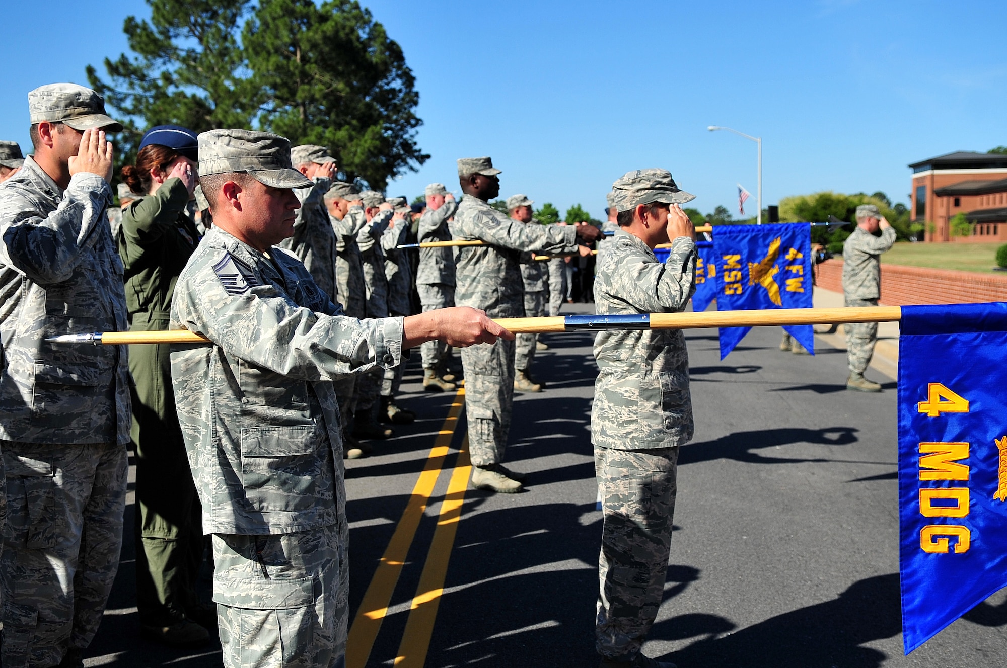 Airmen assigned to the 4th Fighter wing present arms during the national anthem at the 4th FW change of command ceremony, June 2, 2014, at Seymour Johnson Air Force Base, North Carolina. Col. Mark Slocum assumed command of the 4th FW from Col. Jeannie Leavitt. Leavitt is leaving the 4th FW to become the Principal Military Assistant to the Secretary of Defense at the Pentagon. (U.S. Air Force photo/Airman 1st Class Shawna L. Keyes)