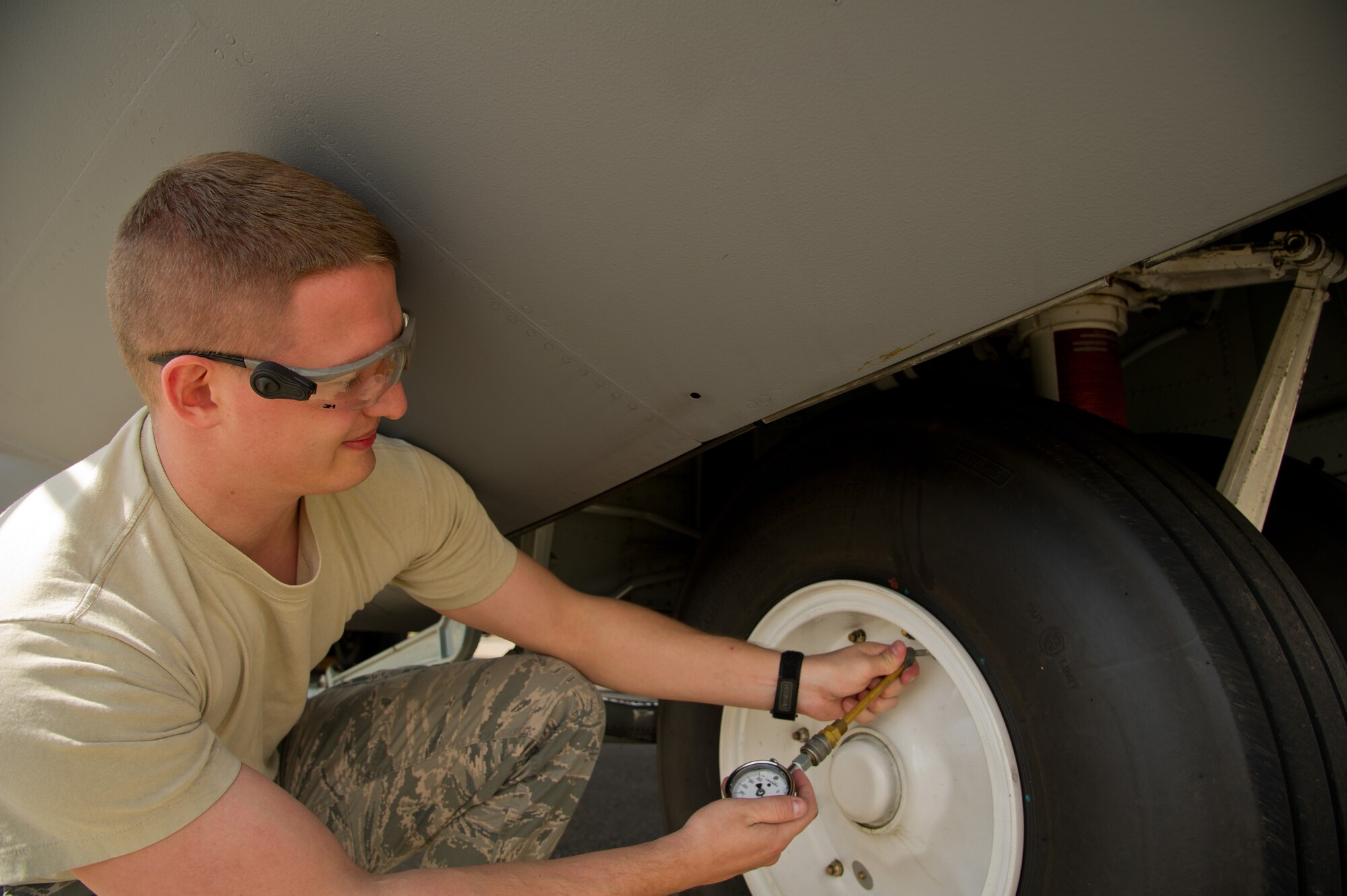 U.S. Air Force Senior Airman Brandon Berens, crew chief, 934th Airlift Wing, Minneapolis Air Reserve Station, Minn., checks the tire pressure of a C-130 Hercules aircraft during Maple Flag 47 in Edmonton/Cold Lake, Alberta, Canada, May 30, 2014. Maple Flag is an international exercise designed to enhance the interoperability of C-130 aircrews, maintainers and support specialists in a simulated combat environment. (U.S. Air Force photo by Tech. Sgt. Matthew Smith/Released)
