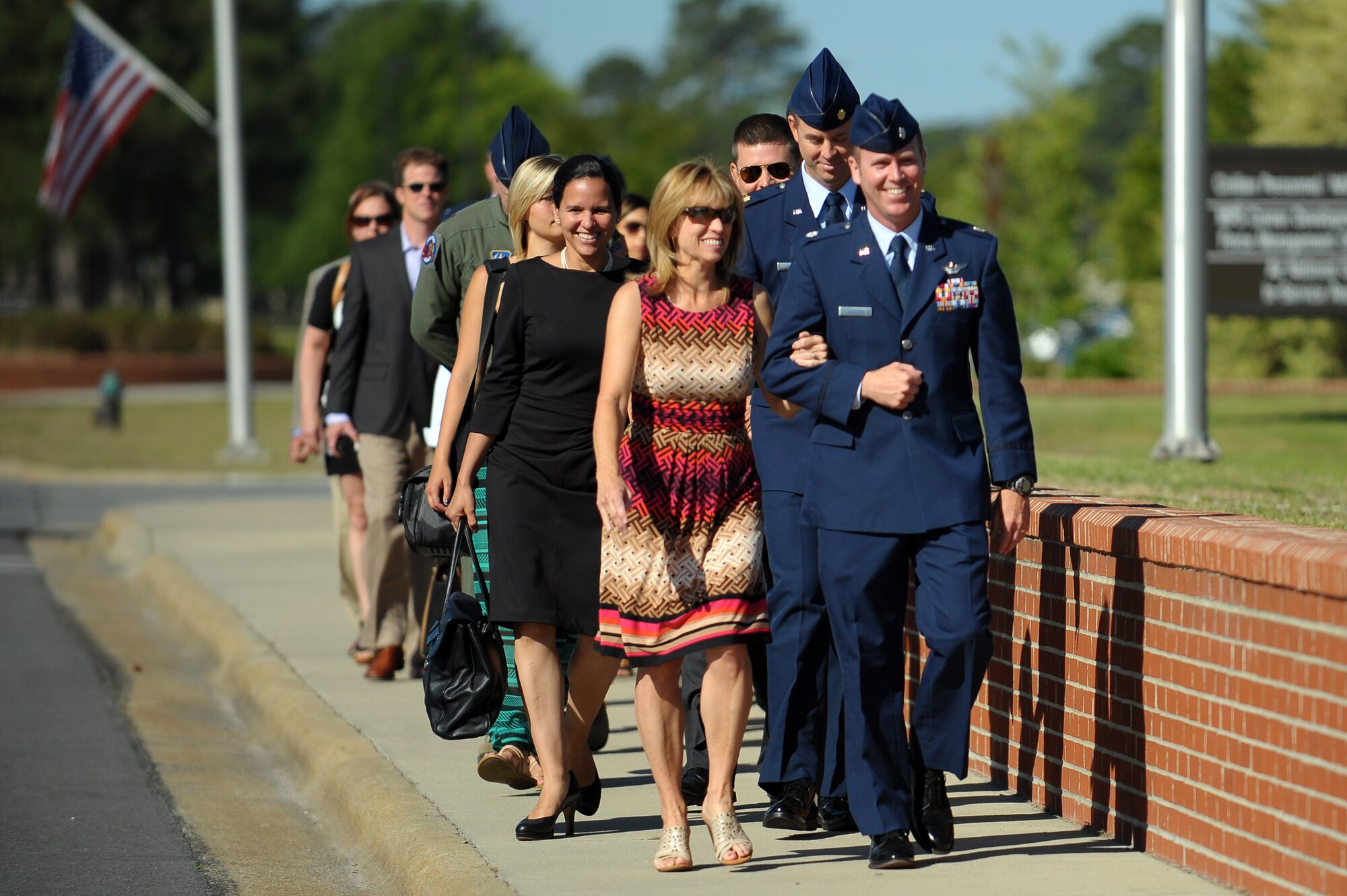 Family members and friends of the 4th Fighter Wing change of command official party are escorted to their seats, June 2, 2014, at Seymour Johnson Air Force Base, North Carolina. Col. Jeannie Leavitt relinquished command to Col. Mark Slocum during the ceremony following a two year assignment as the 4th FW commander. (U.S. Air Force photo/Tech. Sgt. Brittany E. Jones)