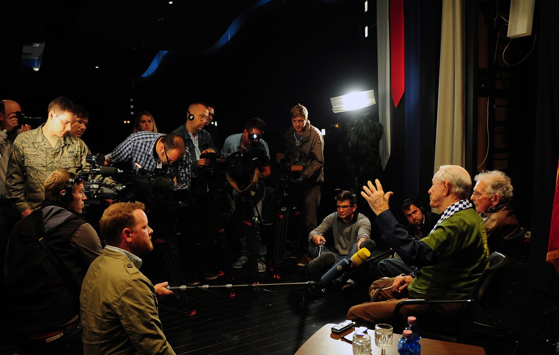 Julian Rice (seated left) and William Prindible, World War II veterans and former 37th Troop Carrier Squadron C-47 Skytrain pilots, answer questions from members of the media before telling their story to members of Team Ramstein. Rice and Prindible were invited by the 37th Airlift Squadron to participate in events commemorating the 70th anniversary of the D-Day invasion of Normandy. (U.S. Air Force photo/Staff Sgt. Kris Levasseur)