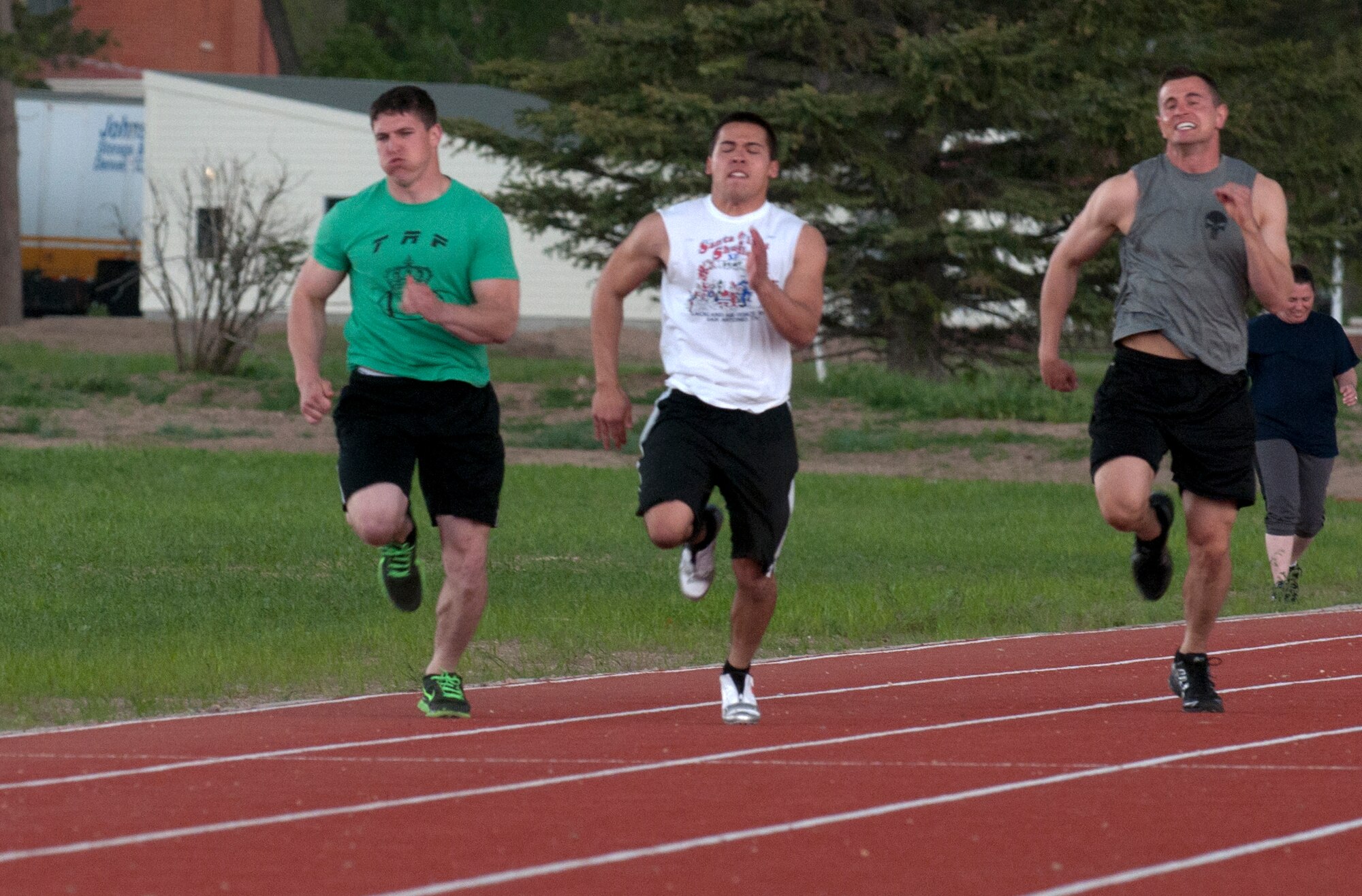 Senior Airman Nicholas Howard, 90th Security Forces Group, left, Airman Damian Dimmick, 90th Security Forces Squadron, center, and Staff Sgt. Joshua Hansen, 90th SFG, right, race May 29 during the opening ceremony for the base track outside of the Freedom Hall Fitness Center. Dimmick took first place in the 100-yard dash and the 50-yard dash for males. (U.S. Air Force photo by Airman Malcolm Mayfield)