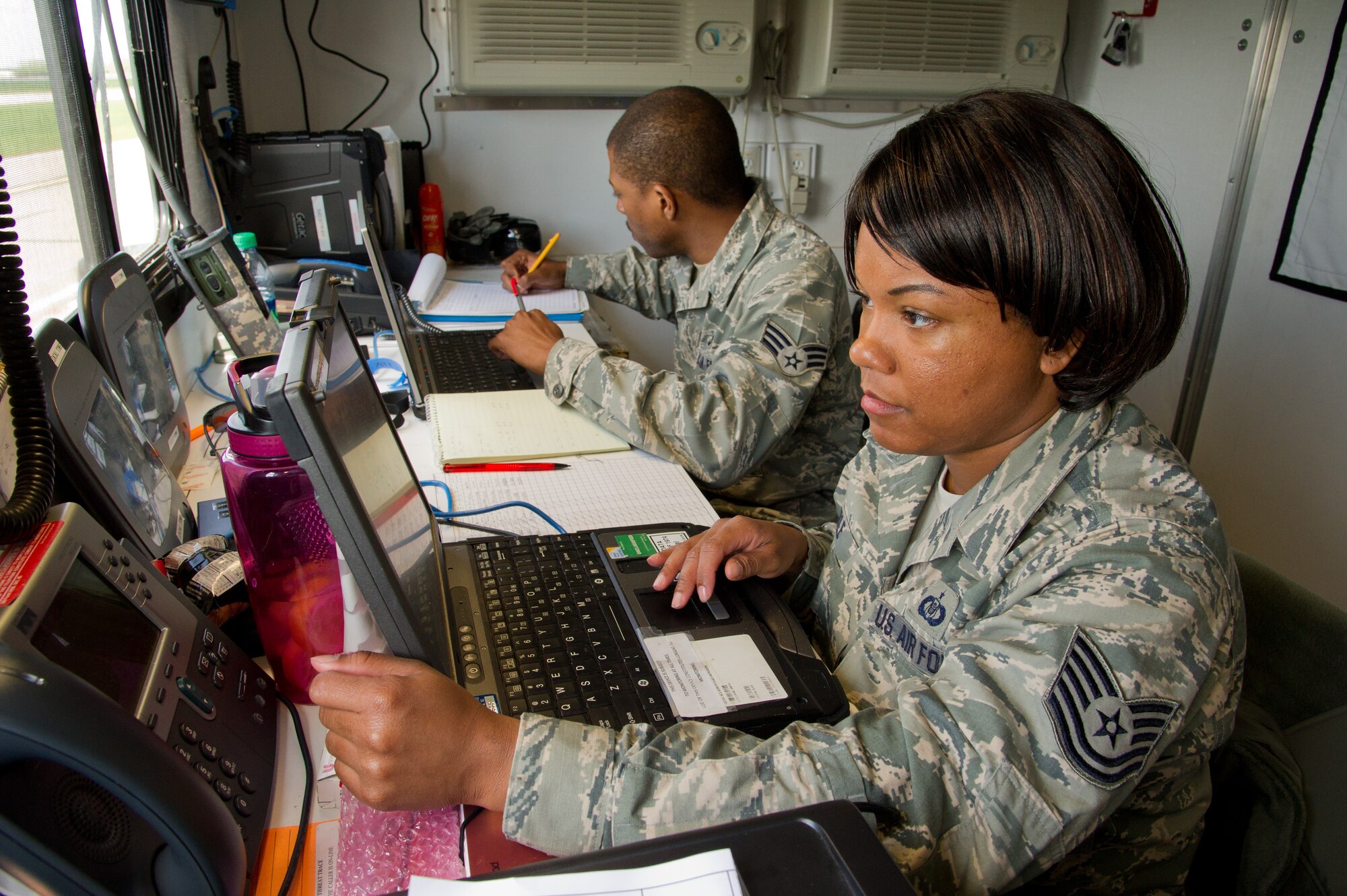 U.S. Air Force Tech. Sgt. Leah Carle, command post craftsman, and Senior Airman Anthony Powell, command post journeyman, both with the 315th Airlift Control Flight, Joint Base Charleston, S.C., monitor flight missions during Maple Flag 47 in Edmonton/Cold Lake, Alberta, Canada, May 30, 2014. Maple Flag is an international exercise designed to enhance the interoperability of C-130 aircrews, maintainers and support specialists in a simulated combat environment. (U.S. Air Force photo by Tech. Sgt. Matthew Smith/Released)