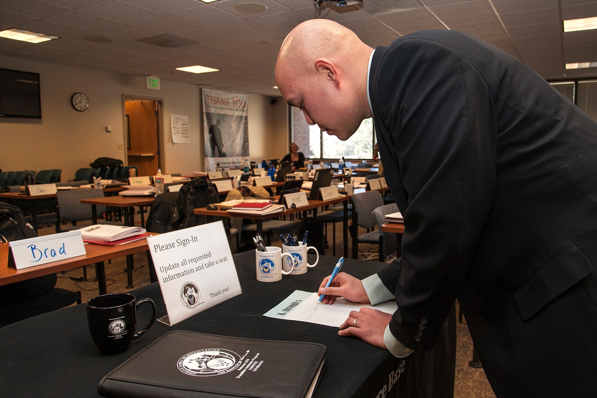 PETERSON AIR FORCE BASE, Colo. -- Staff Sgt. Christopher Patao, 4th Manpower Requirements Squadron management analyst, signs in at the Transition Assistance Program class here March 19. The TAP team’s job is to facilitate, instruct, counsel, schedule and organize everything involved in transitioning a member out of the service. (U.S. Air Force photo/Craig Denton)