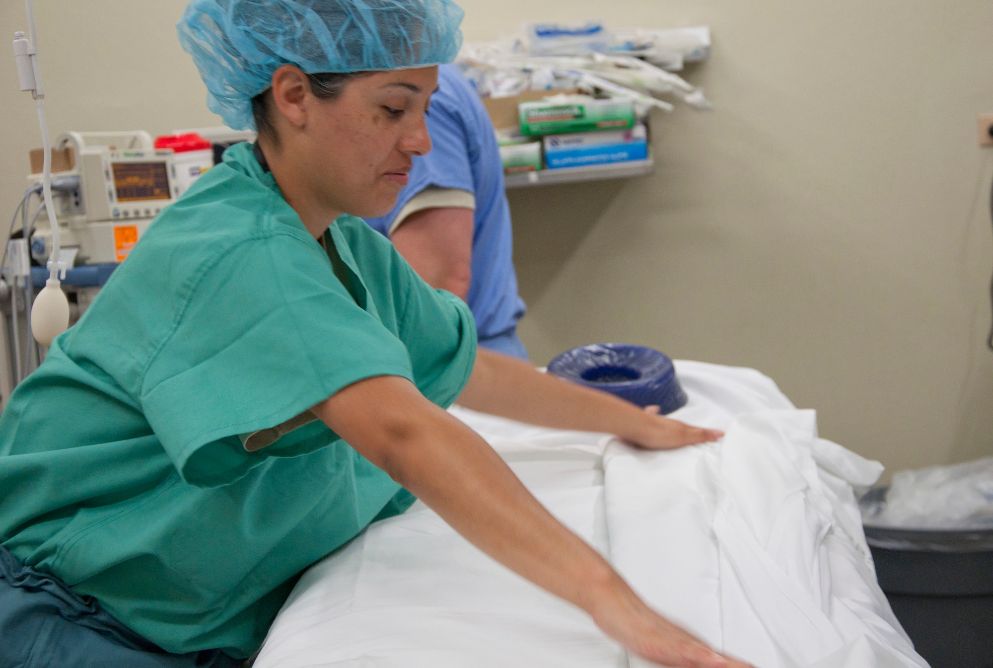 U.S. Air Force Staff Sgt. Nicholasa Partida, surgical service technician, prepares a room for a urology procedure during a New Horizons Belize 2014 medical readiness training exercise May 22, 2014, at the Karl Heusner Memorial Hospital in Belize City, Belize. A U.S. Air Force surgical team arrived in Belize to spend two weeks conducting urology procedures and surgeries in coordination with the KHMH urologist. Approximately 40 patients were screened through the KHMH, and about 20 procedures are planned during this phase of the training exercise. (U.S. Air Force photo by Tech. Sgt. Kali L. Gradishar/Released)