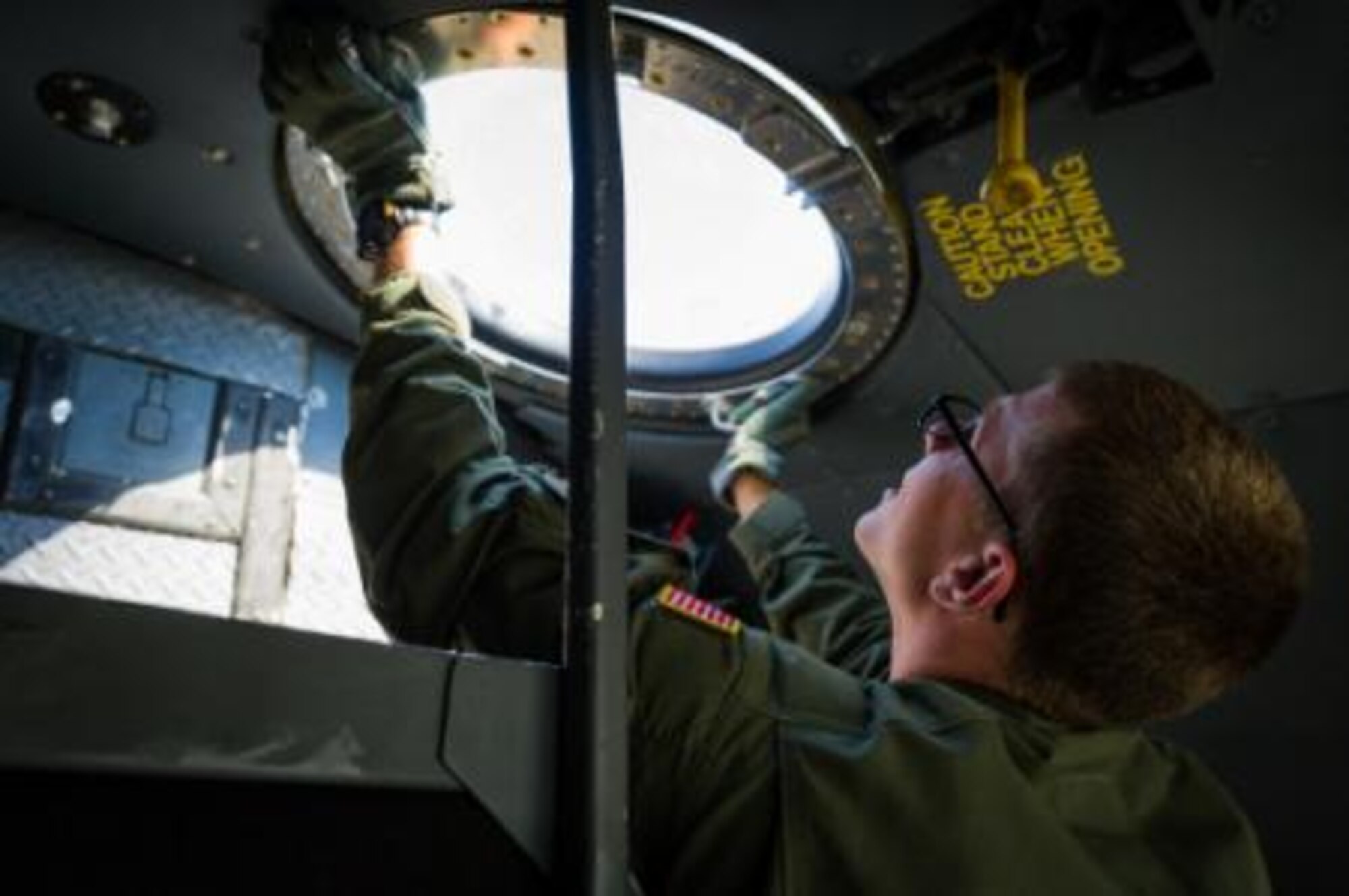U.S. Air Force Senior Airman Adam Strom, C-130 Hercules loadmaster with the 94th Airlift Wing, Dobbins Air Reserve Base, Ga., installs the observation bubble in the forward escape hatch opening during Maple Flag 47 in Edmonton/Cold Lake, Alberta, Canada, May 30, 2014. Maple Flag is an international exercise designed to enhance the interoperability of C-130 aircrews, maintainers and support specialists in a simulated combat environment. (U.S. Air Force photo by Master Sgt. John R. Nimmo, Sr./Released)