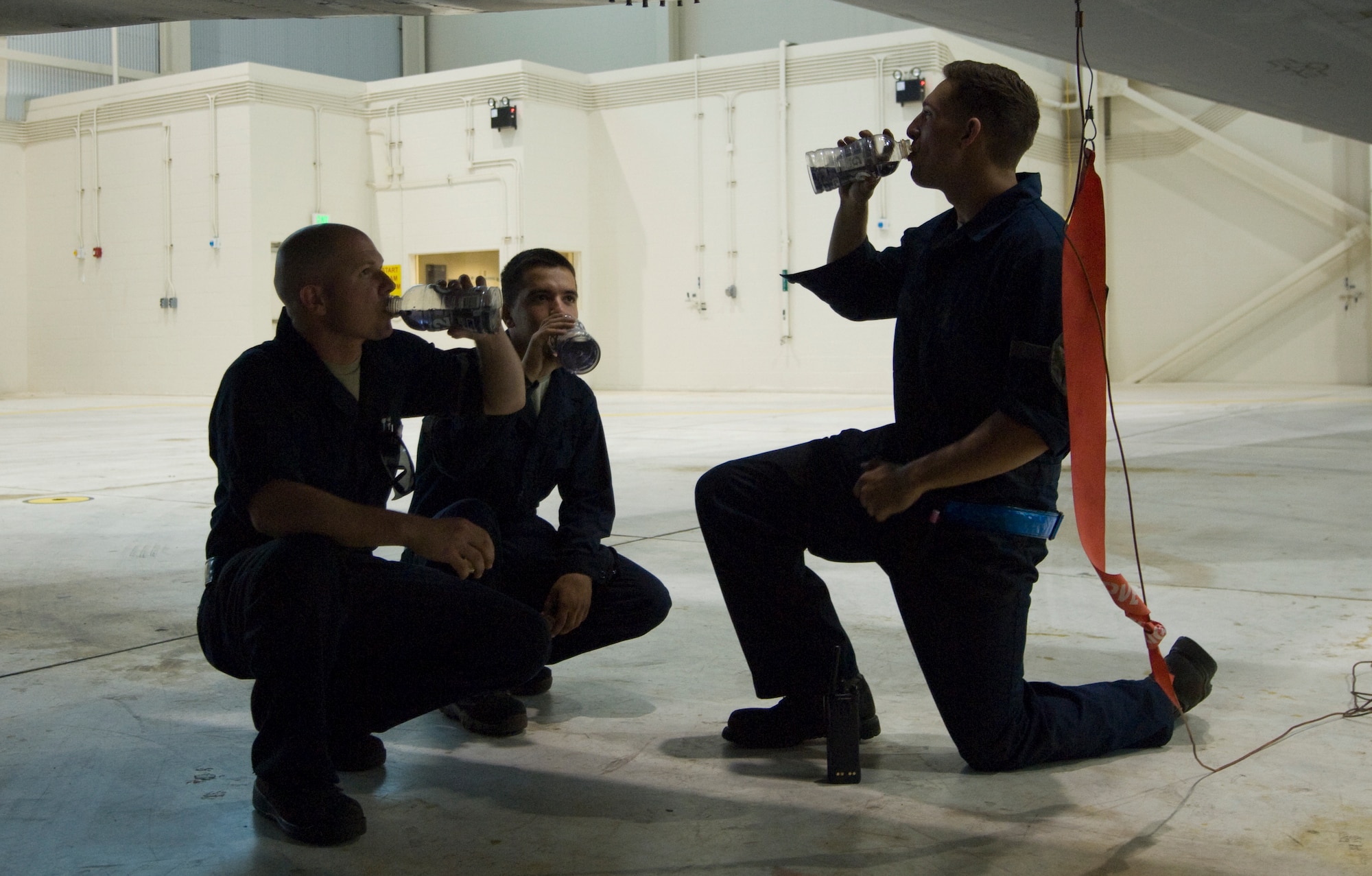 From left, Airman 1st Class Michael Cameron, Airman 1st Class Nolan Gray and Senior Airman Steven Hand, 7th Aircraft Maintenance Squadron hydraulic specialists, hydrate on May 29, 2014, at Dyess Air Force Base. Maintaining proper hydration during the summer is essential to avoiding heat-related illnesses. Common heat-related illnesses that occur in the summer include heat exhaustion, heatstroke and dehydration. (U.S. Air Force photo by Airman 1st Class Kylsee Wisseman/Released)