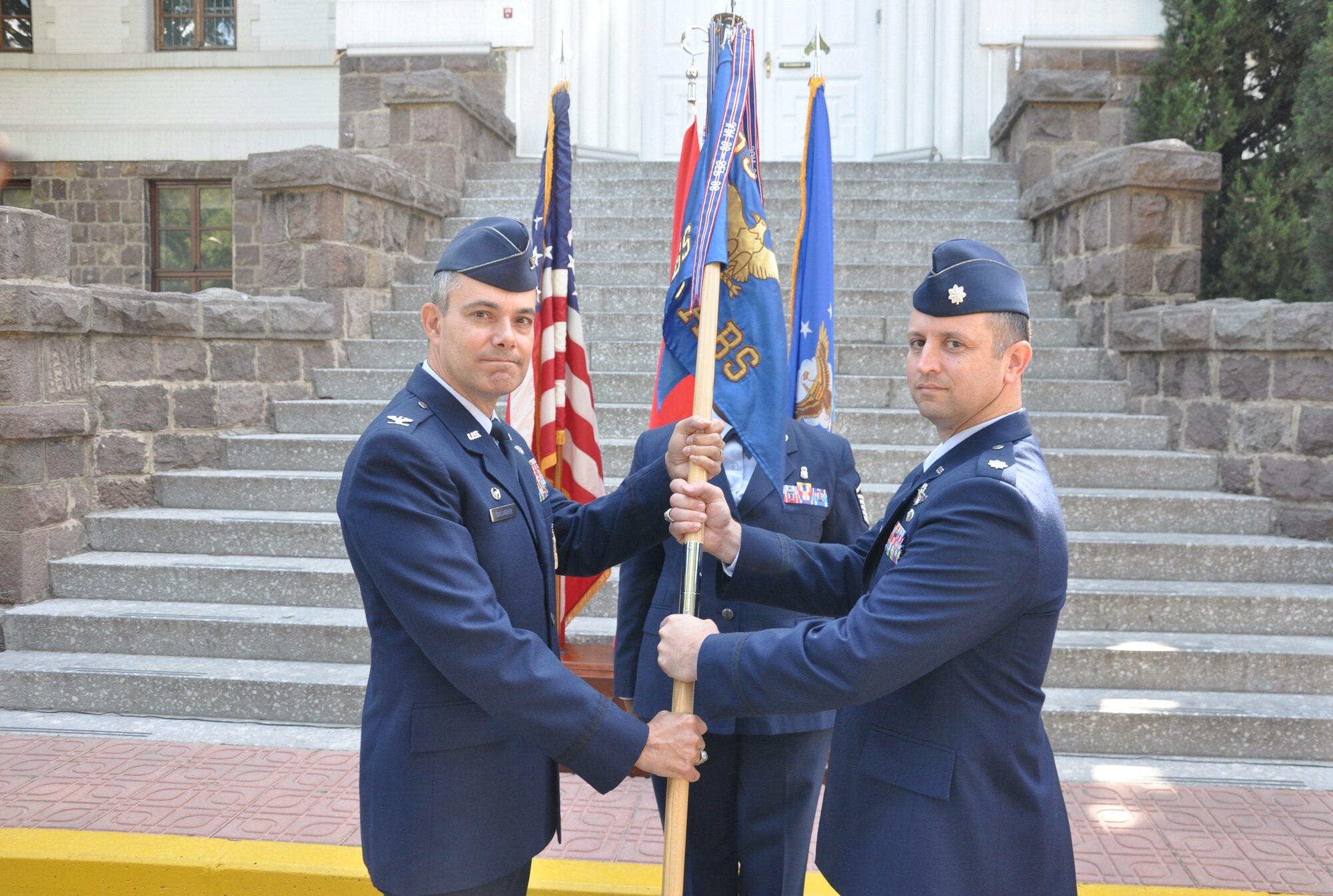 Lt. Col. John Thomas, right, assumes command of the 425th Air Base Squadron May 30, 2014, Izmir, Turkey. The 425th Air Base Squadron performs as administrative agent and provides mission support for the NATO Allied Land Command Headquarters, Izmir as well as six other associate units operating in Izmir. (Photo by Tanju Varlıklı/Released)
